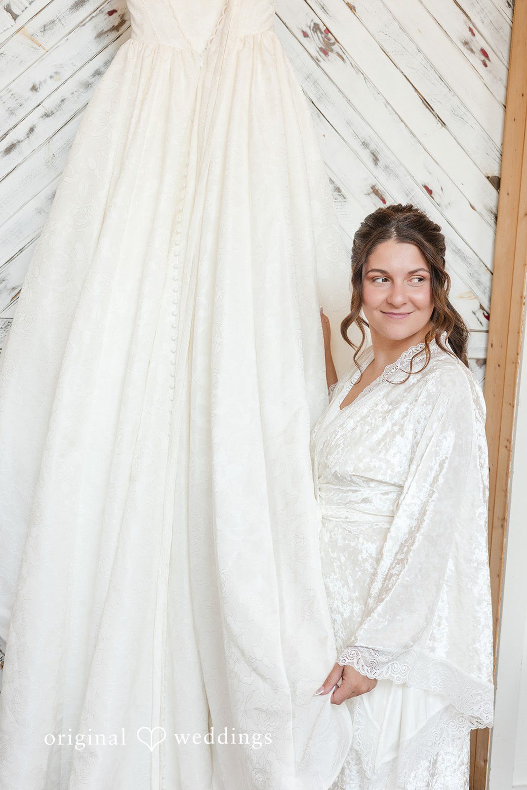 The bride checks out her wedding gown