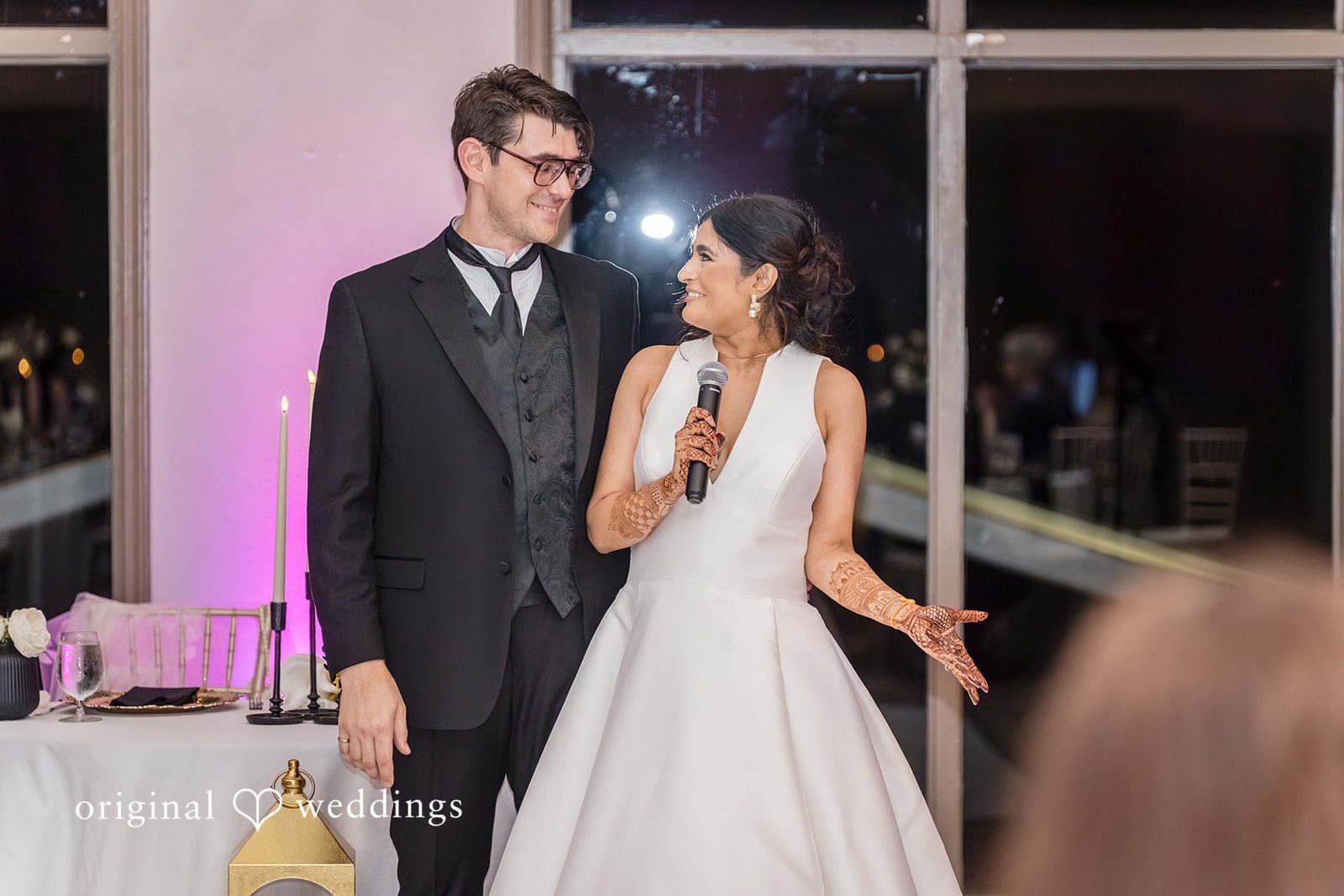 Nicholas + Nisha Bride and groom entering a reception venue together.