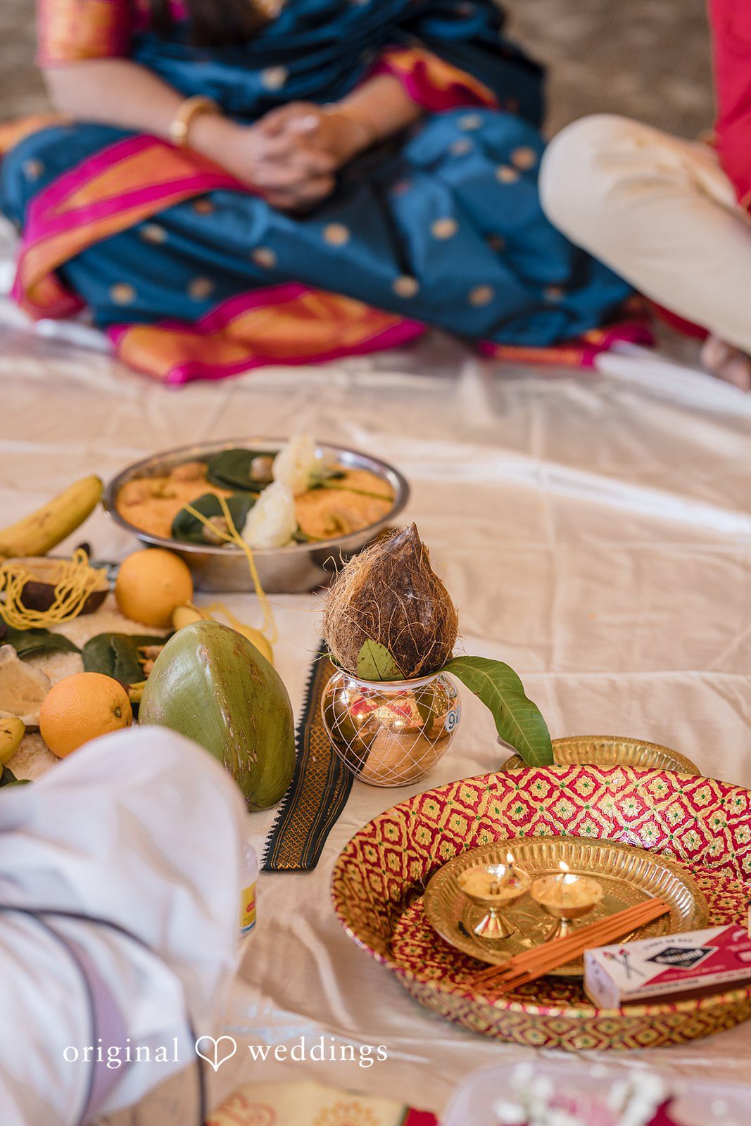 Nicholas + Nisha Close-up of ceremonial wedding items, including vibrant fabrics and decorative platters.