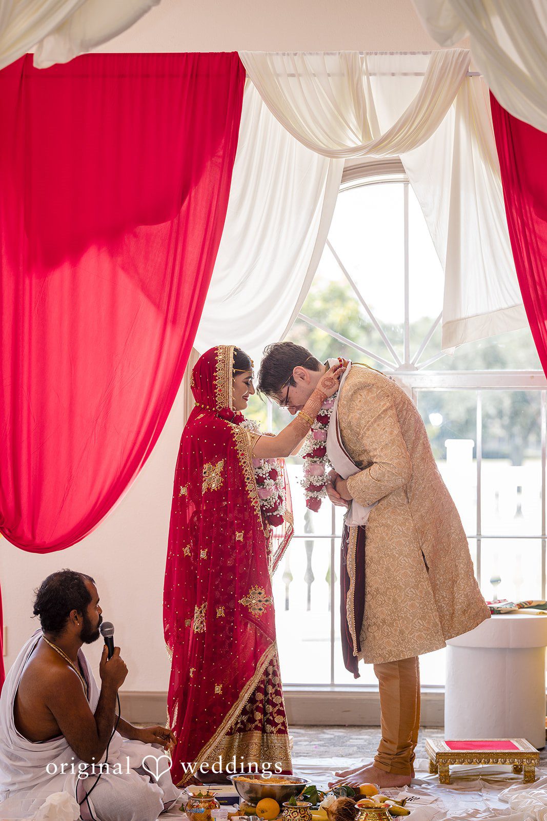 Nicholas + Nisha Individuals exchanging vows or garlands during a wedding ritual.