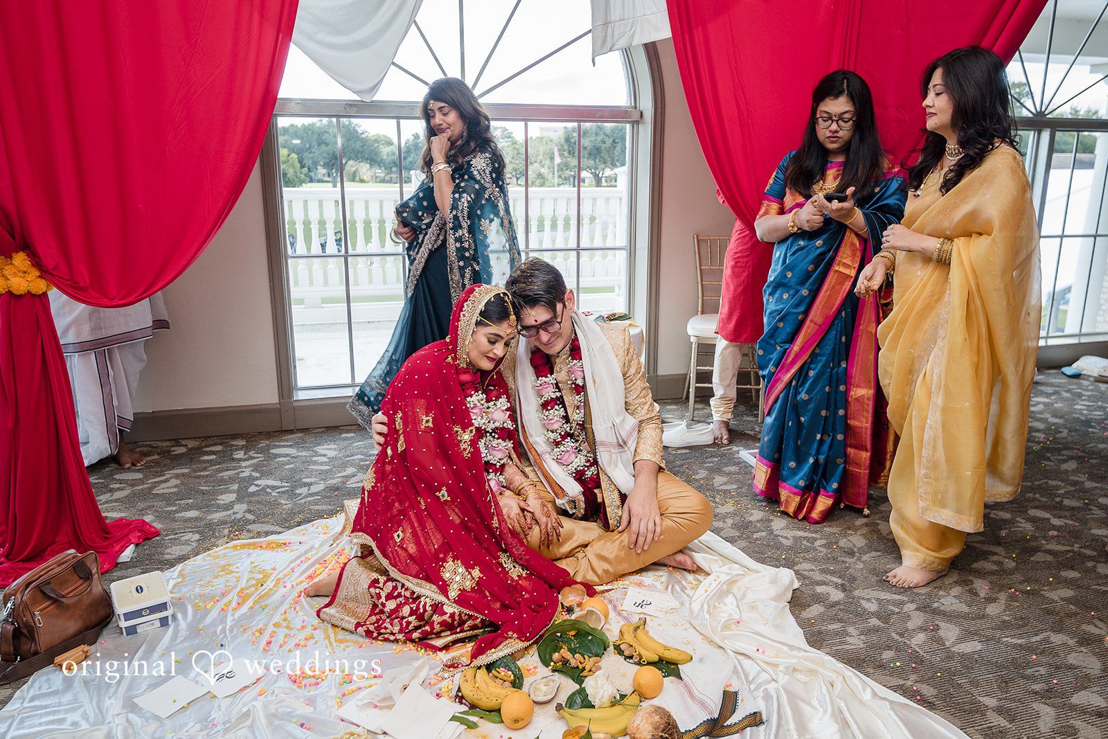 Nicholas + Nisha Wedding guests standing around a beautifully decorated ceremonial area.