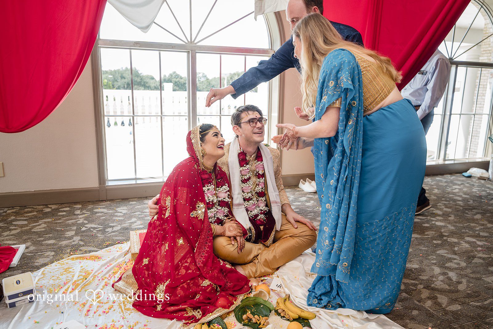 Nicholas + Nisha Guest in a blue dress watching a traditional wedding ceremony take place.