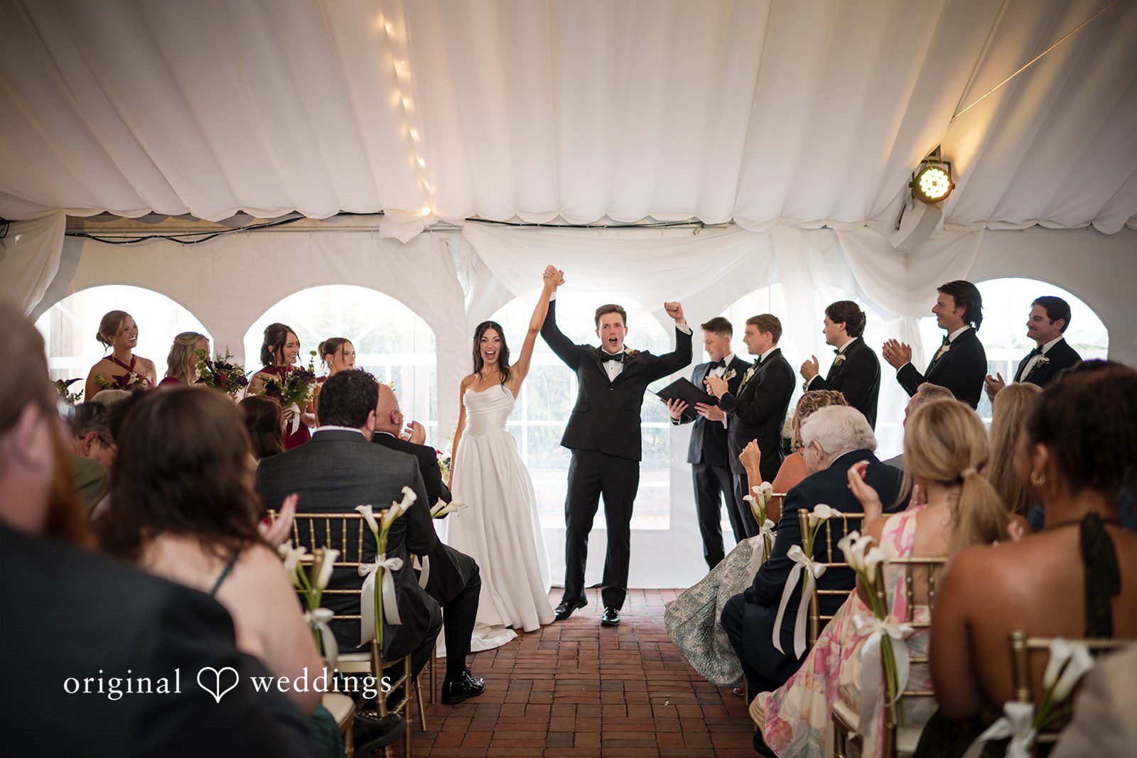 Macy + Nolan A wedding ceremony with the officiant and wedding party standing before the guests.