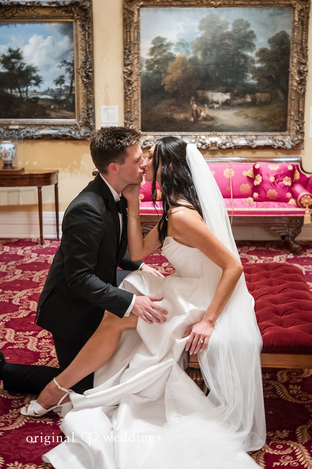 Macy + Nolan A bride and groom sitting closely together on an ornate sofa.