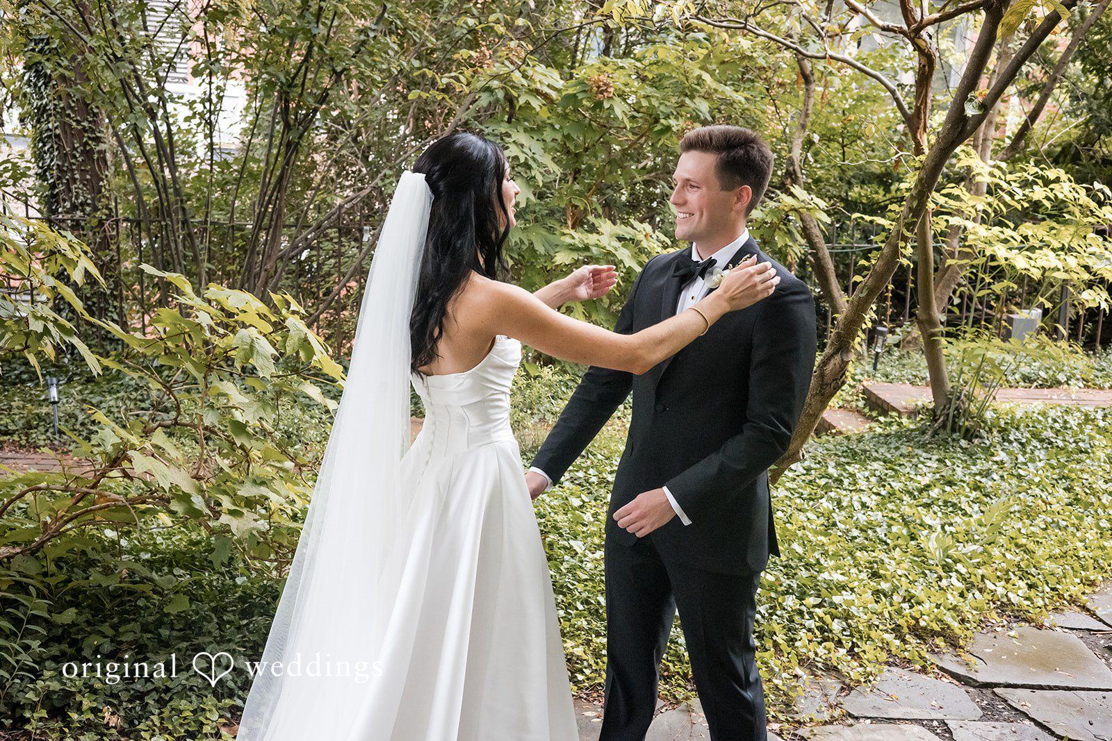 Macy + Nolan A bride and groom standing together near trees.