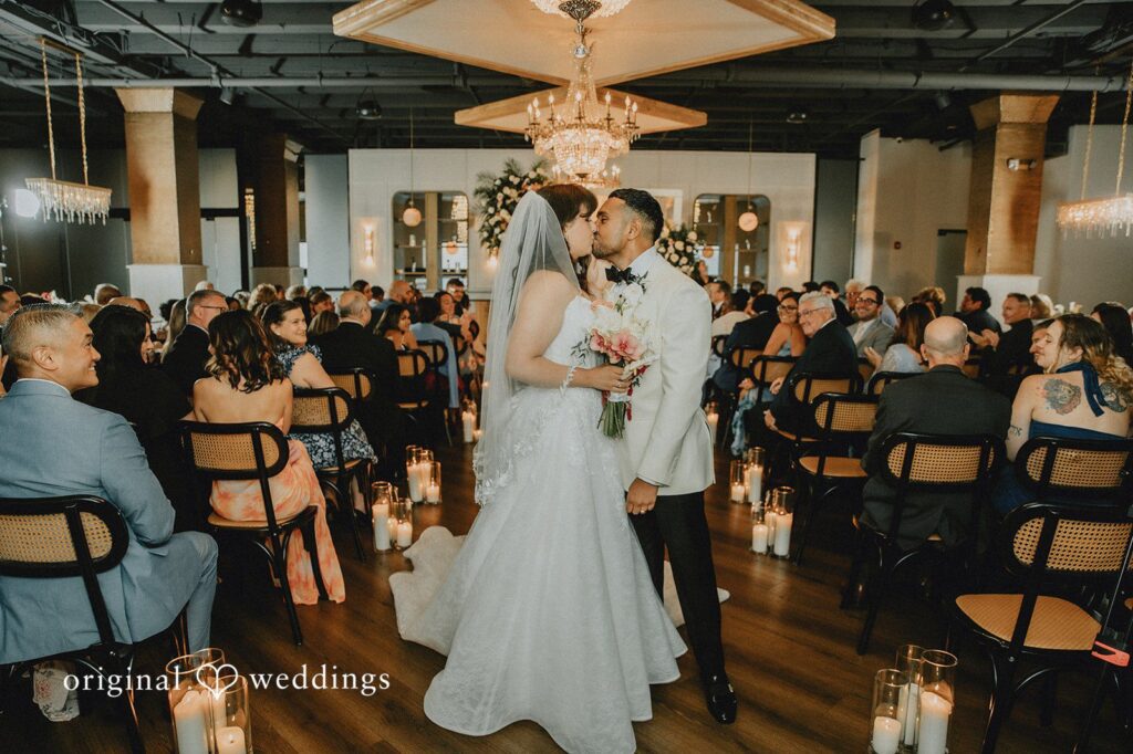 Sasha + Jason Our Philadelphia wedding photographers at Original Weddings captured the moment the couple shared a kiss by the aisle at the Tendenza by Cescaphe