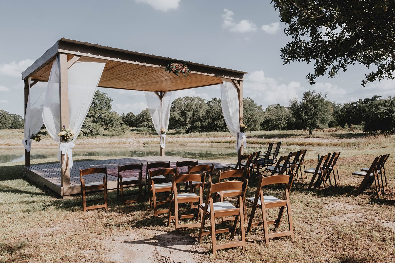 texas-backyard-rustic-austin-megan-kyle-p001-01 Ceremony pergola draped in white at their Texas backyard wedding