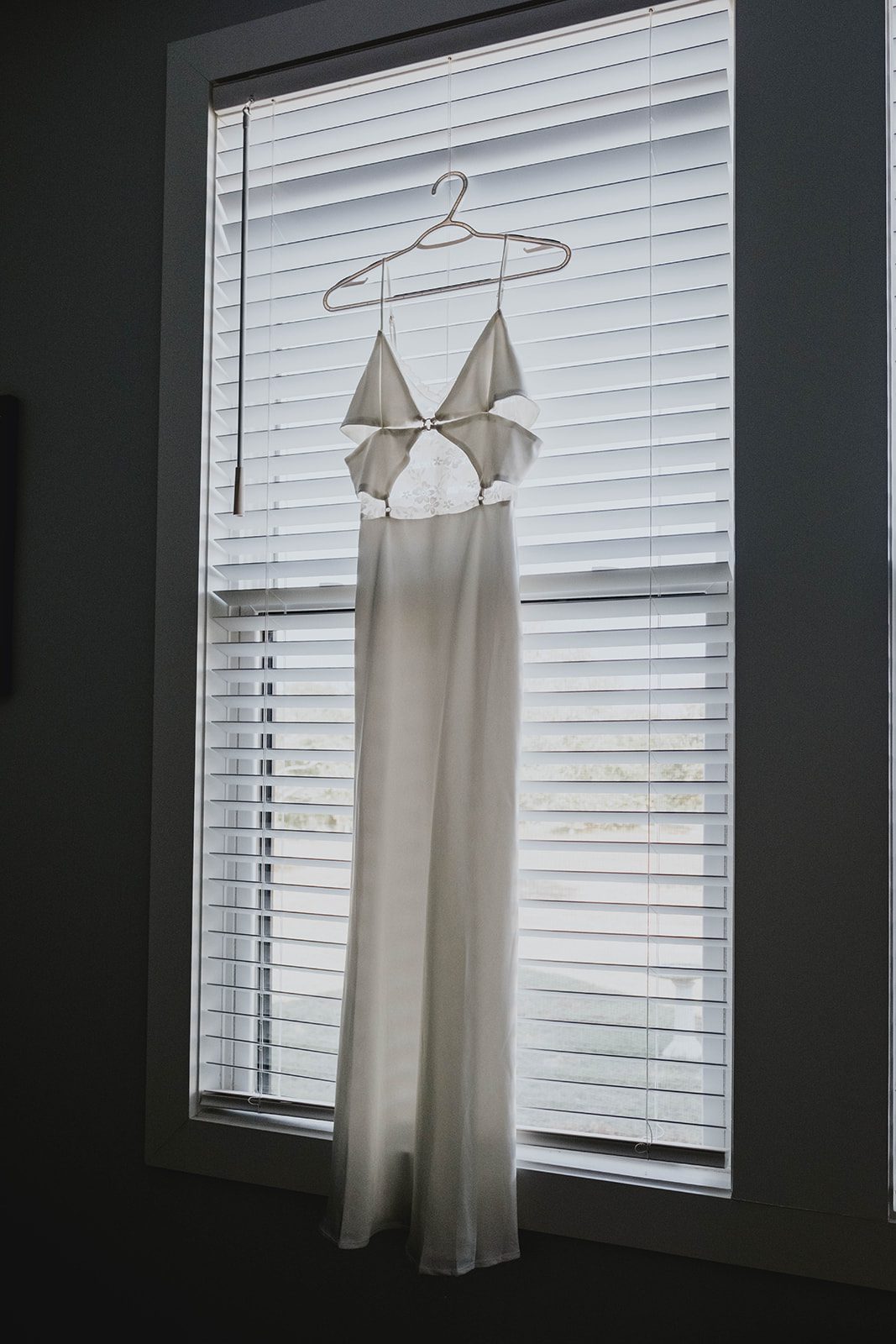 texas-backyard-rustic-austin-megan-kyle-p006-02 Wedding dress hanging in the window