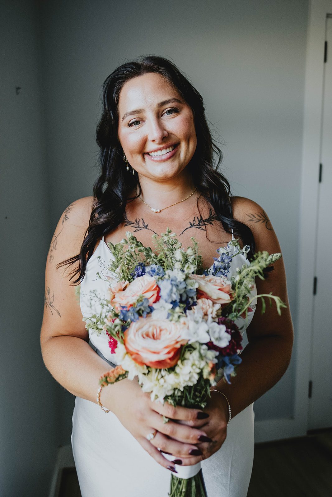 texas-backyard-rustic-austin-megan-kyle-p008-03 Bride smiling with her bouquet at their Texas backyard wedding