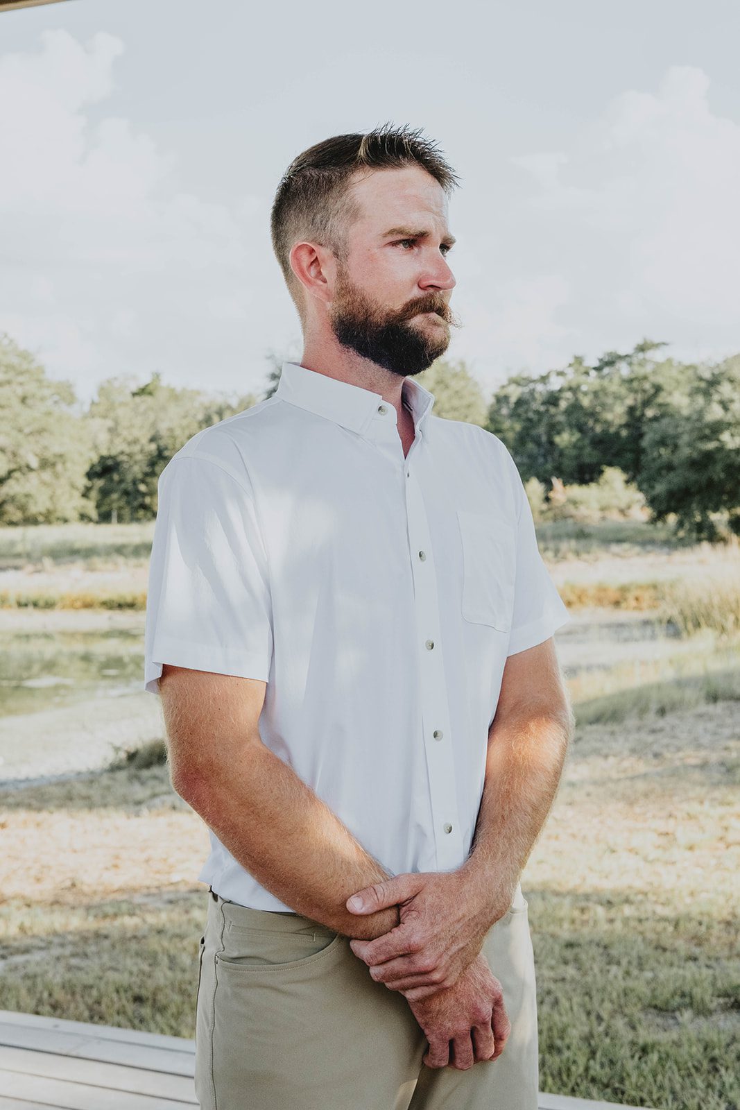 texas-backyard-rustic-austin-megan-kyle-p009-05 Groom waiting in the field before the ceremony