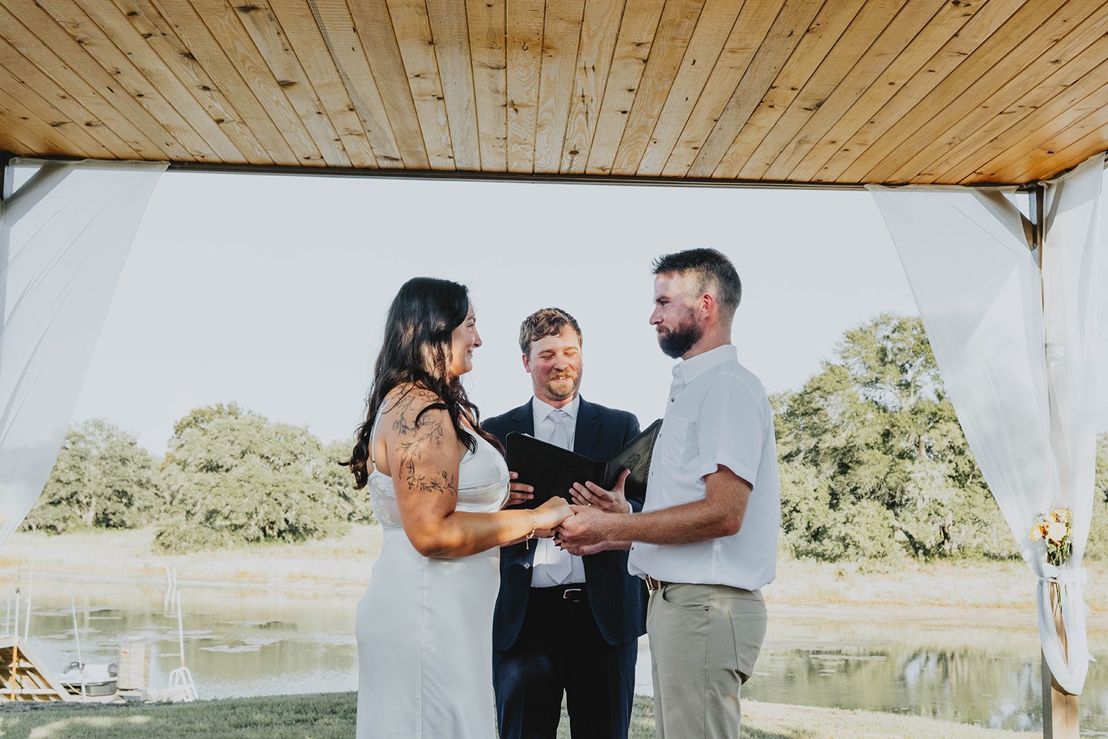 texas-backyard-rustic-austin-megan-kyle-p013-11 Bride and groom during the outdoor ceremony at their Texas backyard wedding