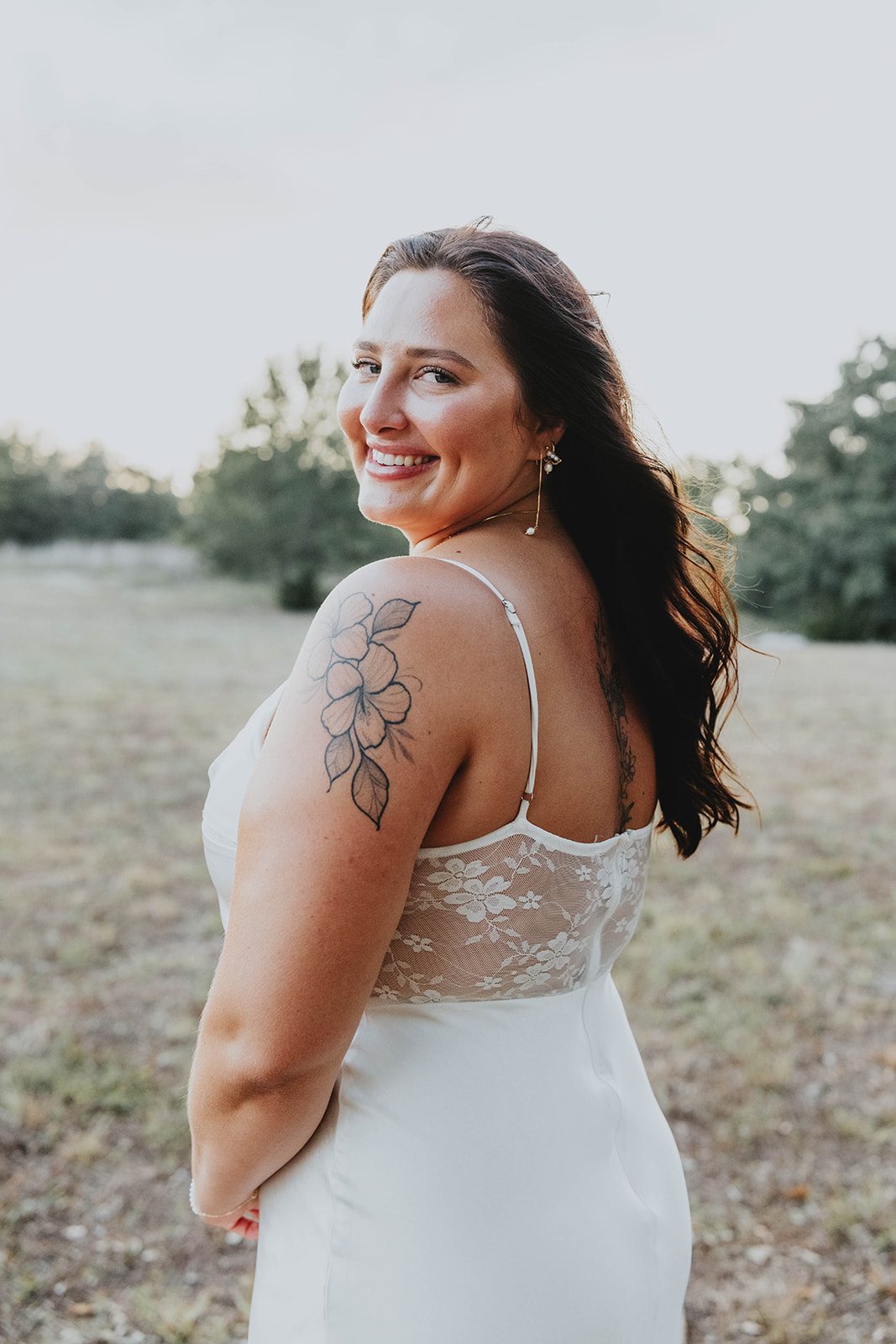 texas-backyard-rustic-austin-megan-kyle-p020-09 Bride smiling over her shoulder