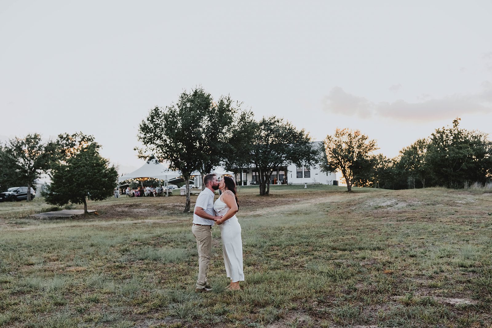 texas-backyard-rustic-austin-megan-kyle-p022-03 Couple standing in the wide open field