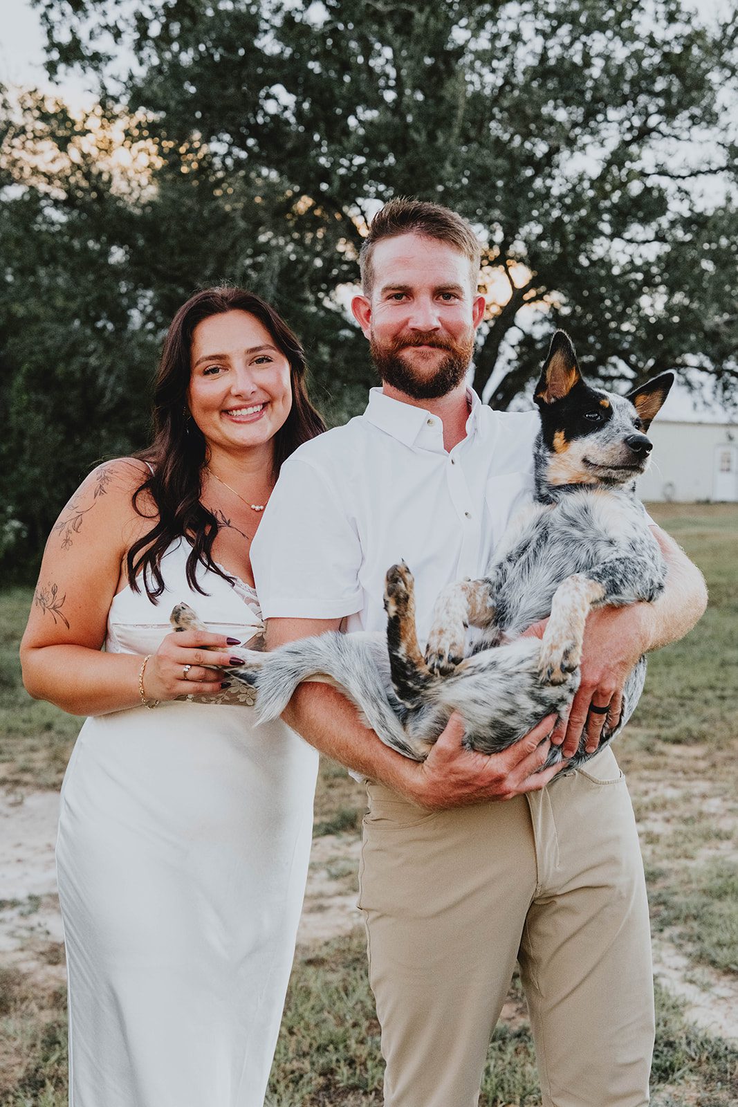 texas-backyard-rustic-austin-megan-kyle-p023-06 Bride and groom posing together under the trees at their Texas backyard wedding