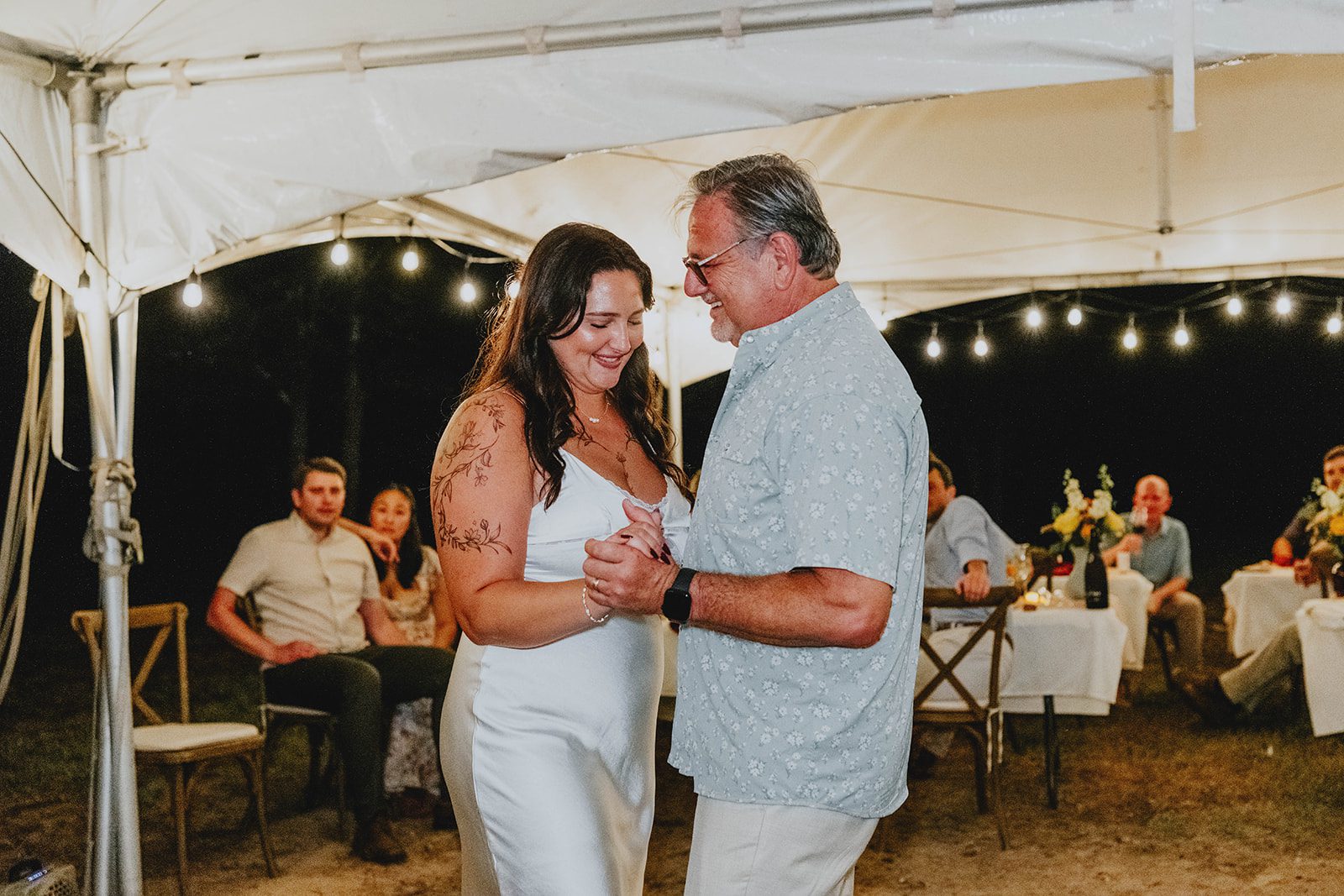 texas-backyard-rustic-austin-megan-kyle-p025-04 Bride and groom dancing under the tent lights, captured by Austin wedding photographers from Original Weddings at their Texas backyard wedding
