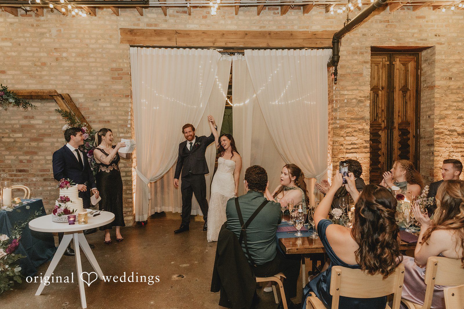The couple makes a joyful entrance to their wedding reception