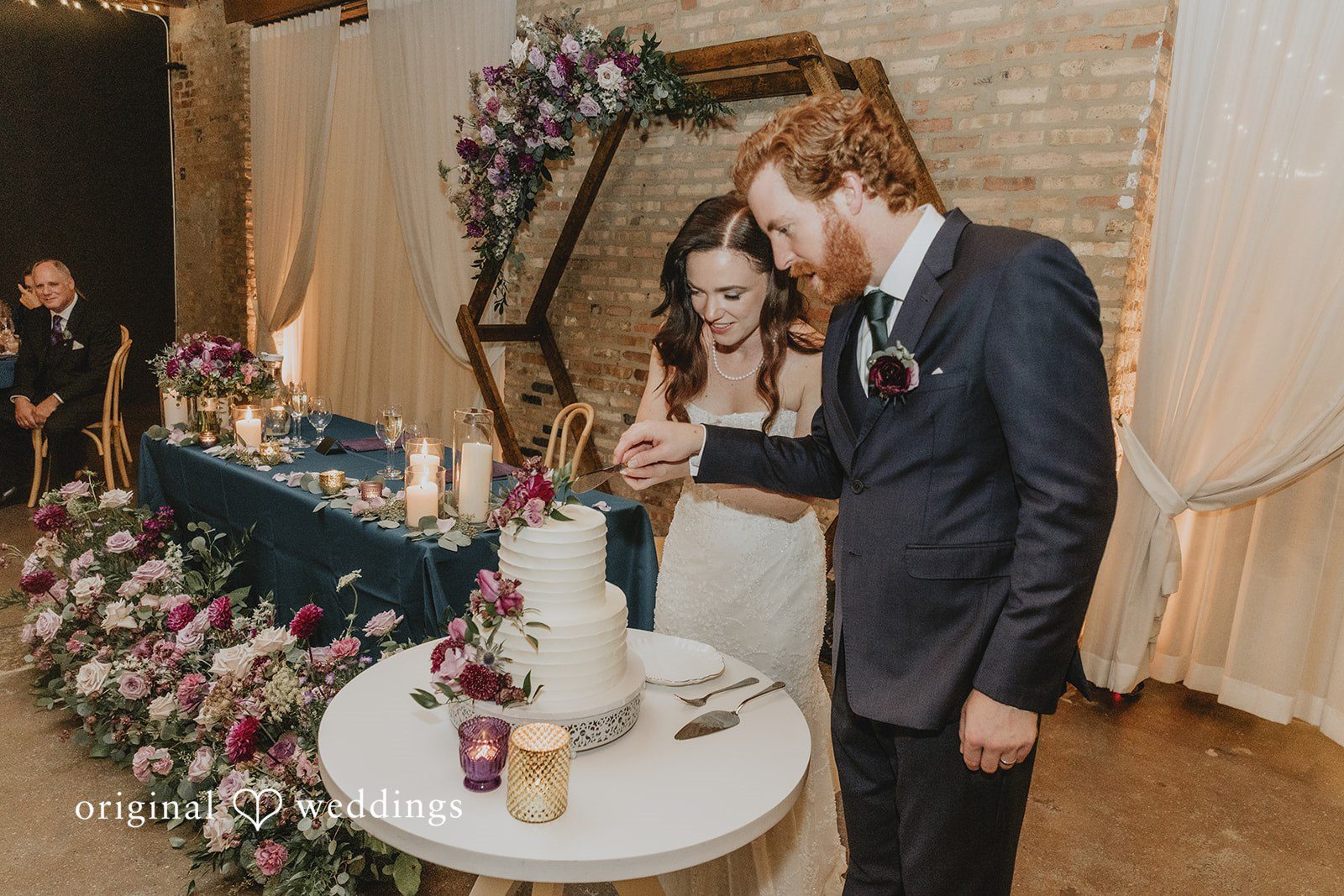 The couple cuts their wedding cake