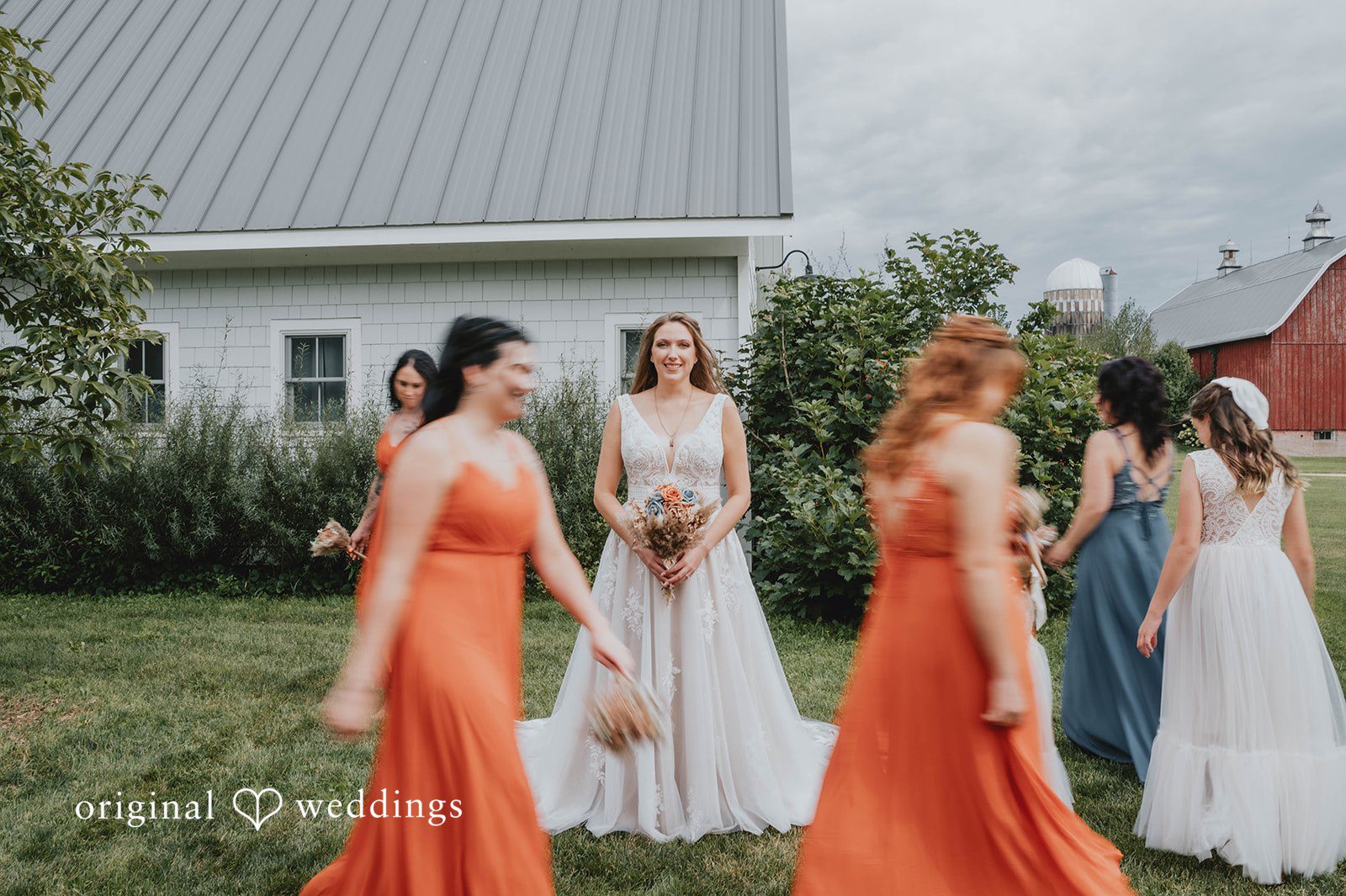 Bridesmaids laughing with the bride