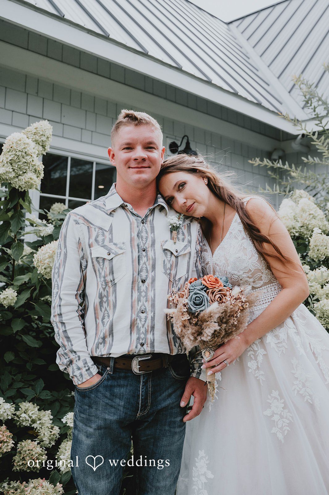 Bride and groom by the hydrangeas at The Barn at Ballard Creek