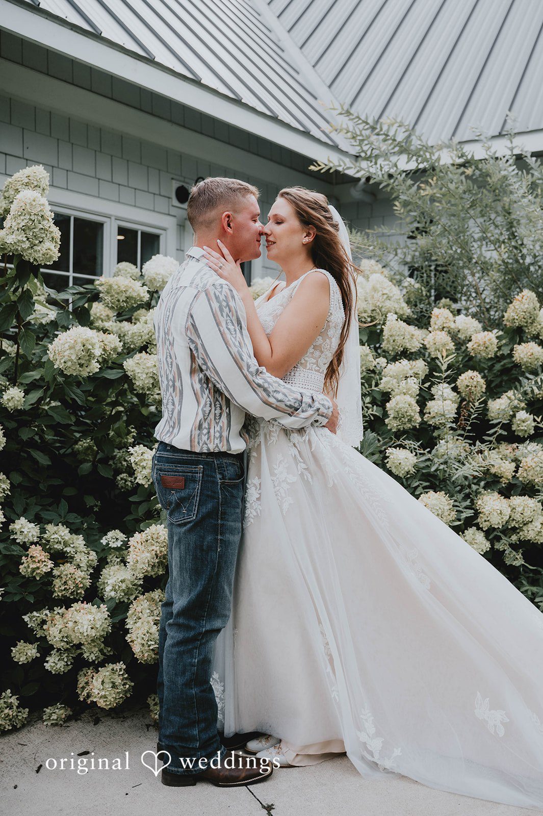 Couple hugging among the flowers