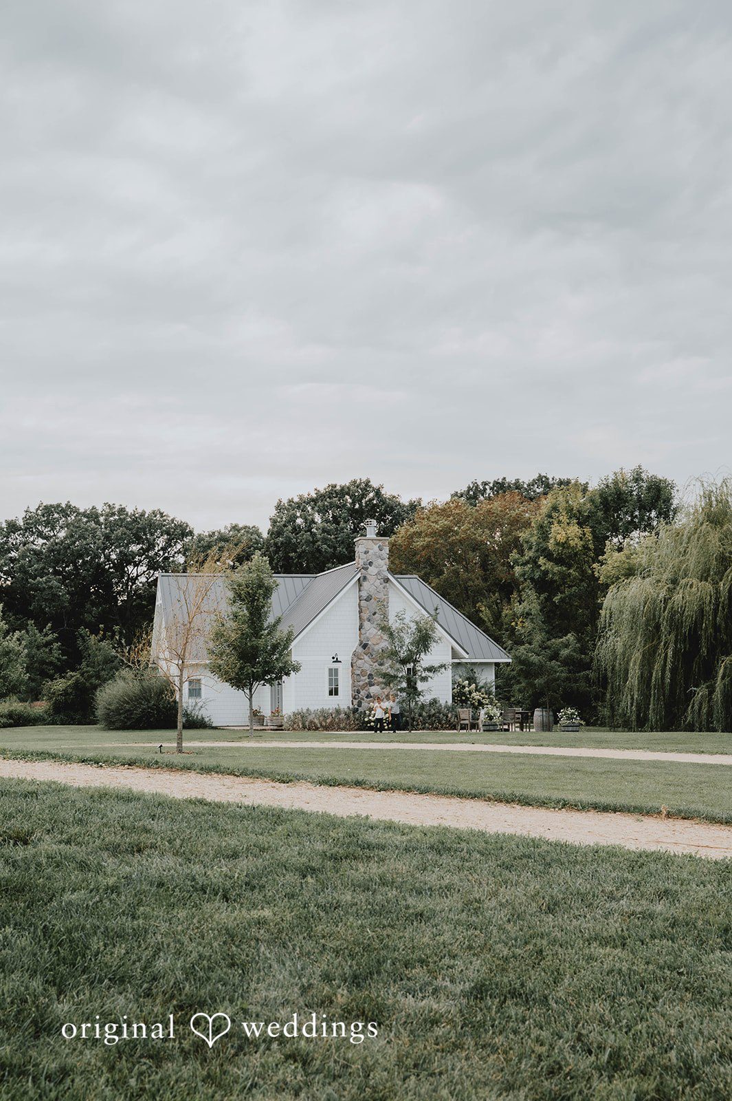 White farmhouse on the property at The Barn at Ballard Creek