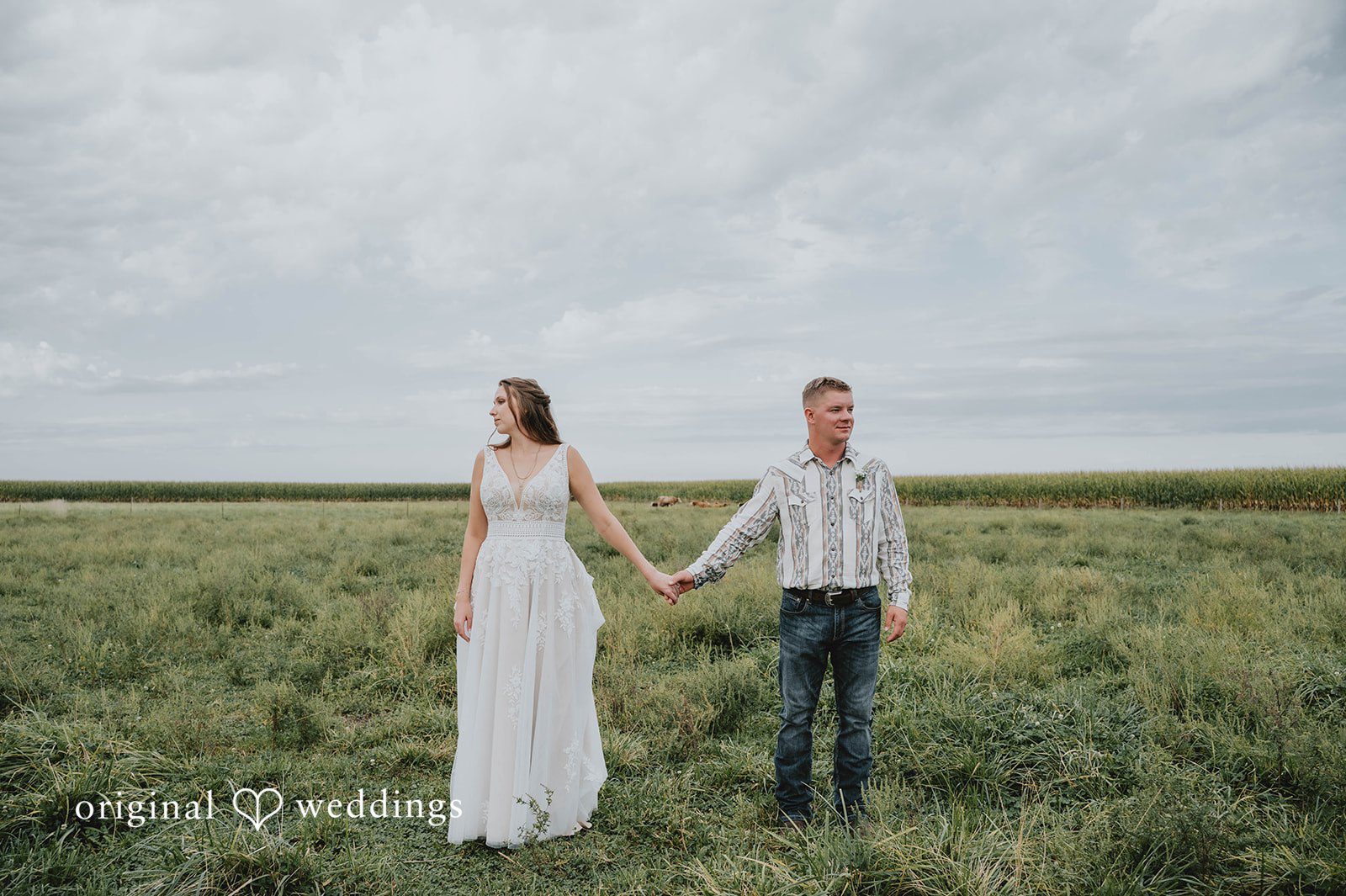 Couple walking in the field at The Barn at Ballard Creek