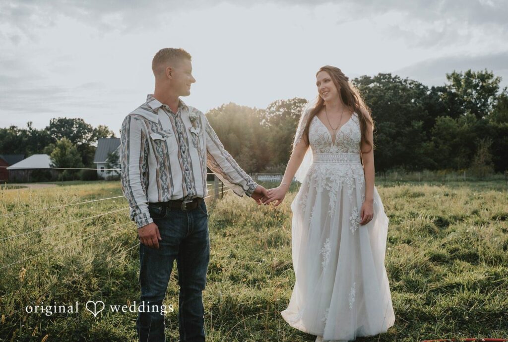 The Barn at Ballard Creek Wedding | Jessica & Michael 4 Couple holding hands in the field, captured by Minneapolis wedding photographers from Original Weddings at The Barn at Ballard Creek