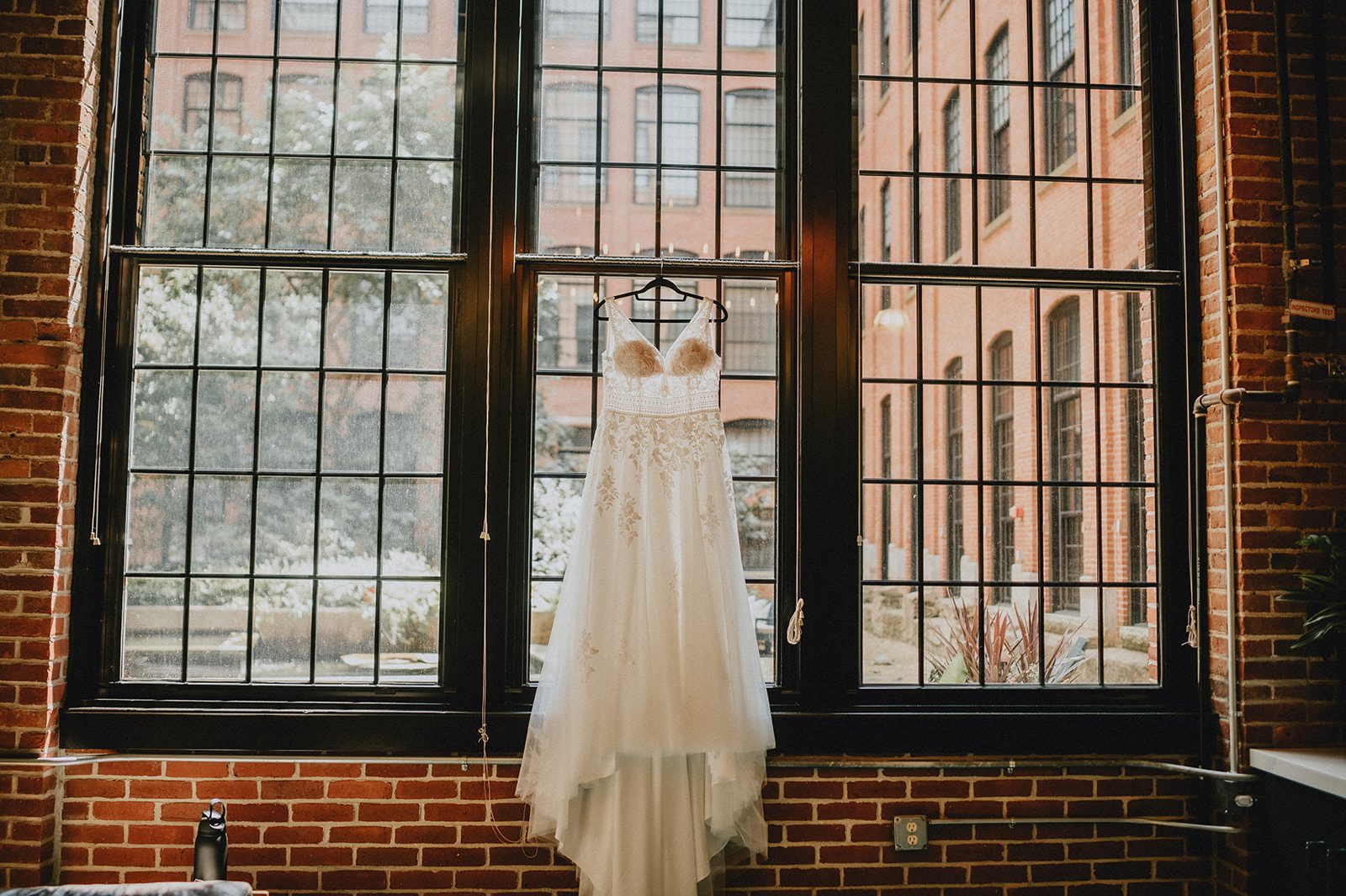 Wedding dress hanging by the windows Wedding dress hanging by the windows