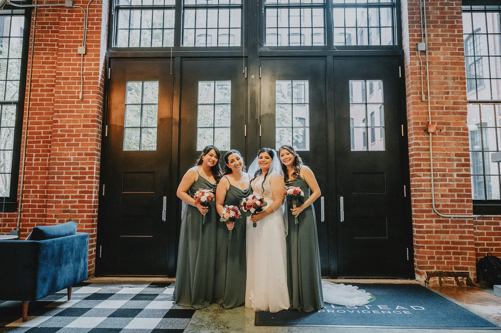 Bride with her bridesmaids at the barn doors at The Barn at Blackstone National Bride with her bridesmaids at the barn doors at The Barn at Blackstone National