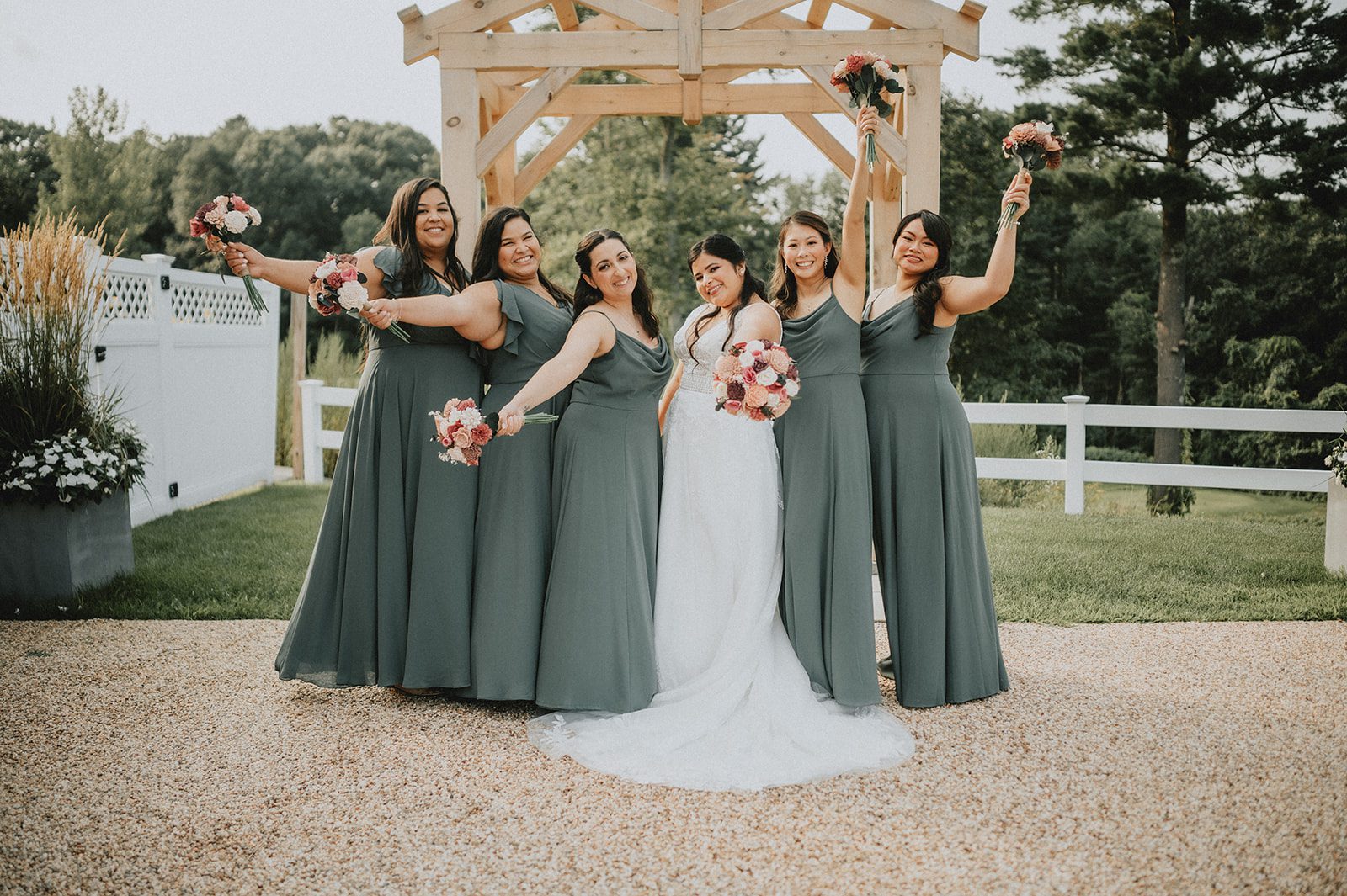 Bride with her bridesmaids outdoors Bride with her bridesmaids outdoors