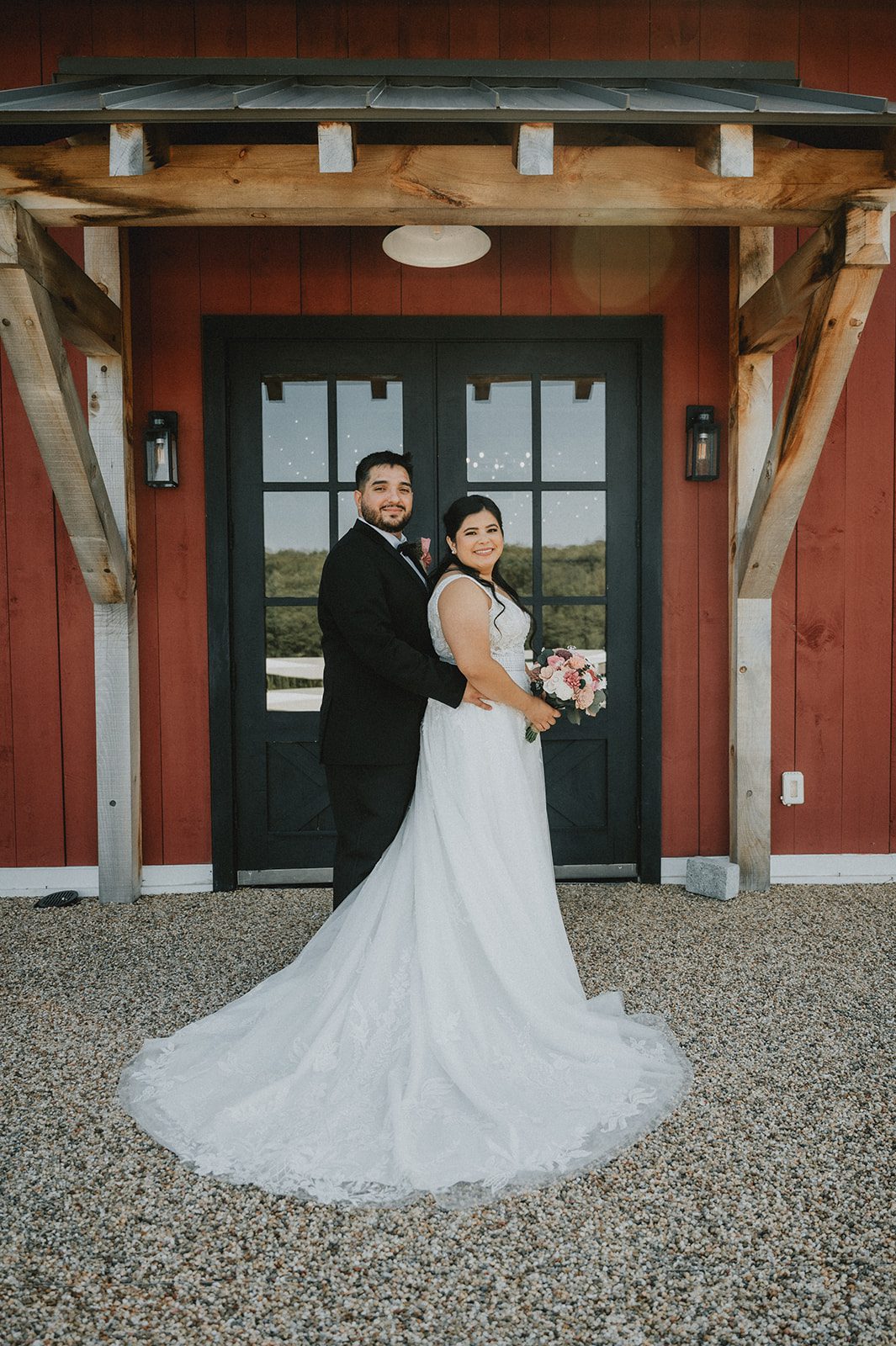 Couple at the barn doors at The Barn at Blackstone National Couple at the barn doors at The Barn at Blackstone National