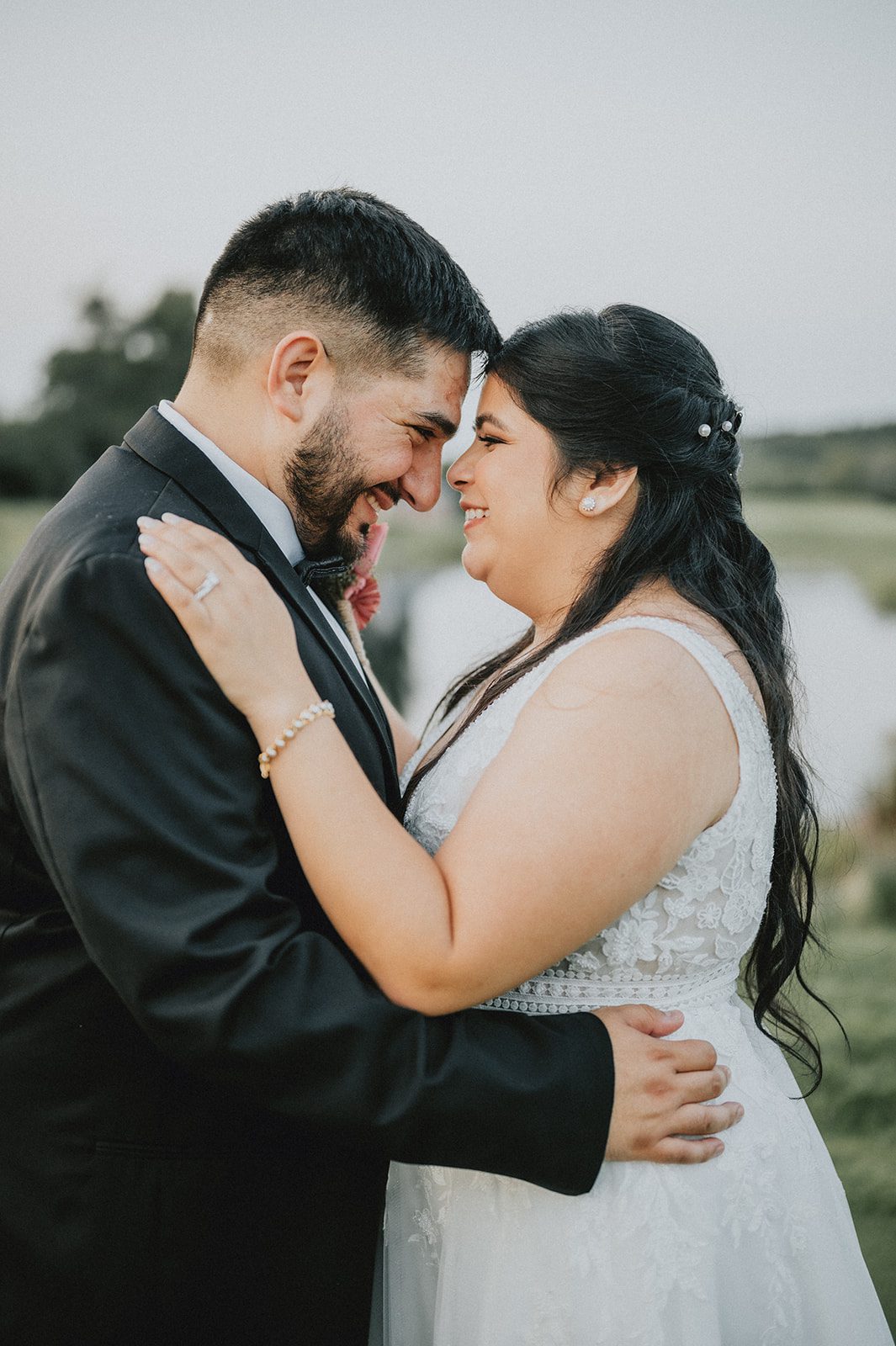 Bride and groom smiling together outdoors Bride and groom smiling together outdoors