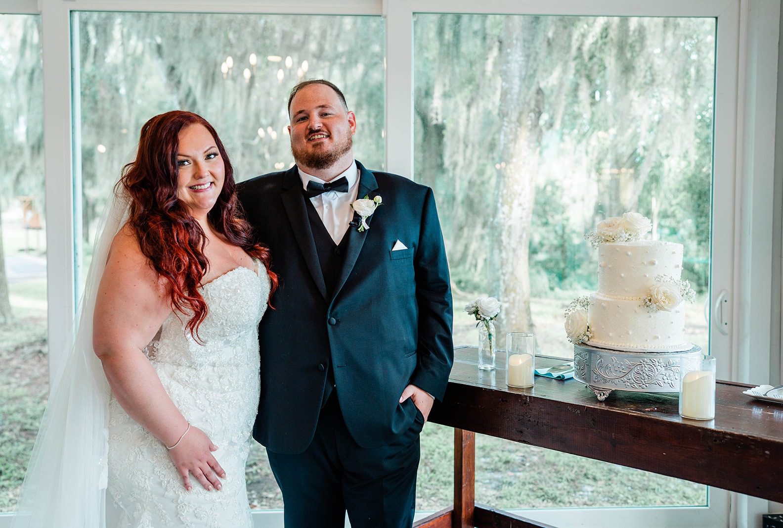 Victoria and John smiling together inside the lakeside barn, captured by Tampa wedding photographers from Original Weddings at The Barn at Crescent Lake