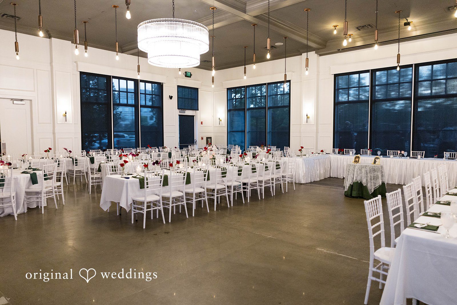 Andrea + Roberto Reception hall set with white tables and tall windows at The Crawford