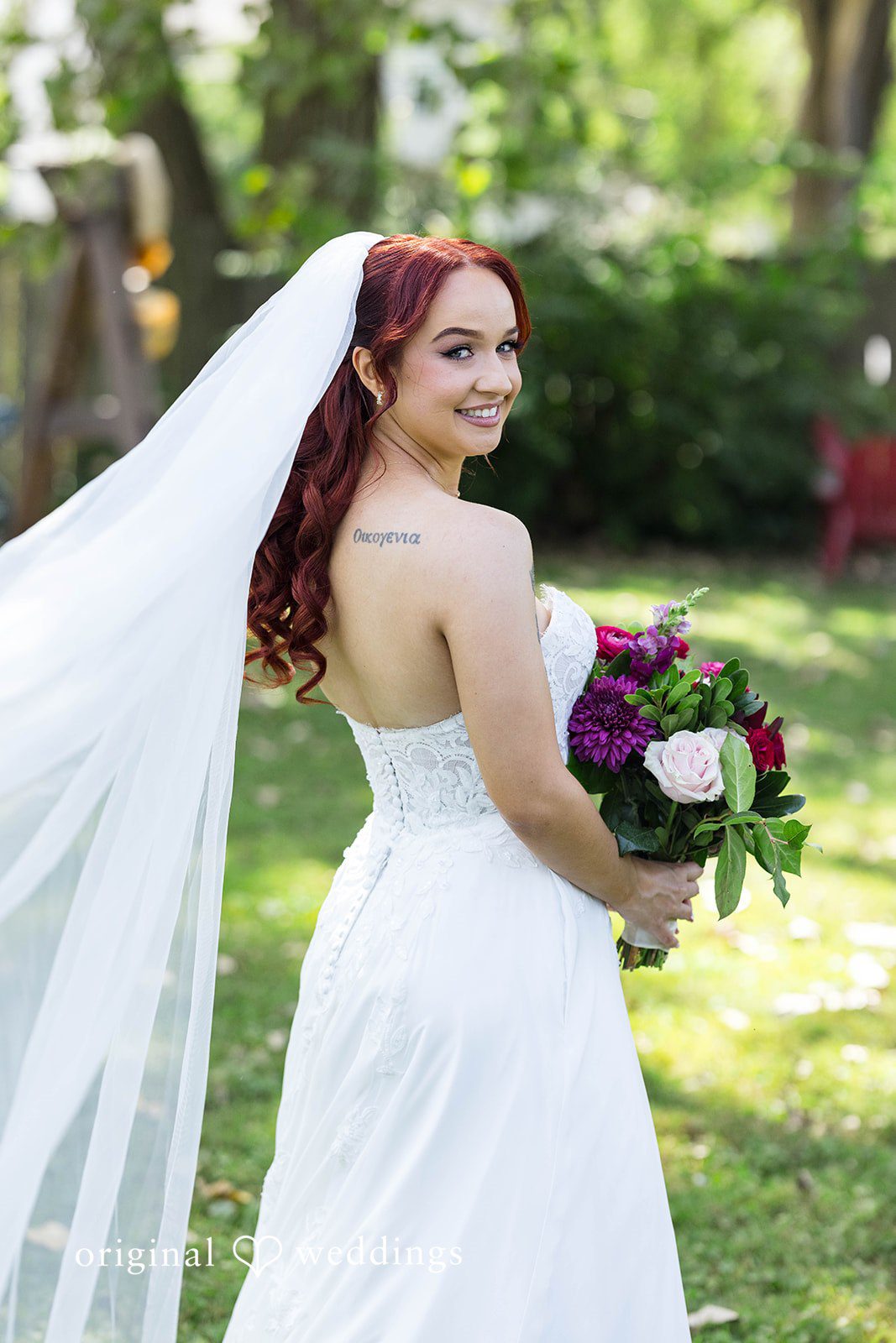Andrea + Roberto Bride in her gown with her bouquet outdoors