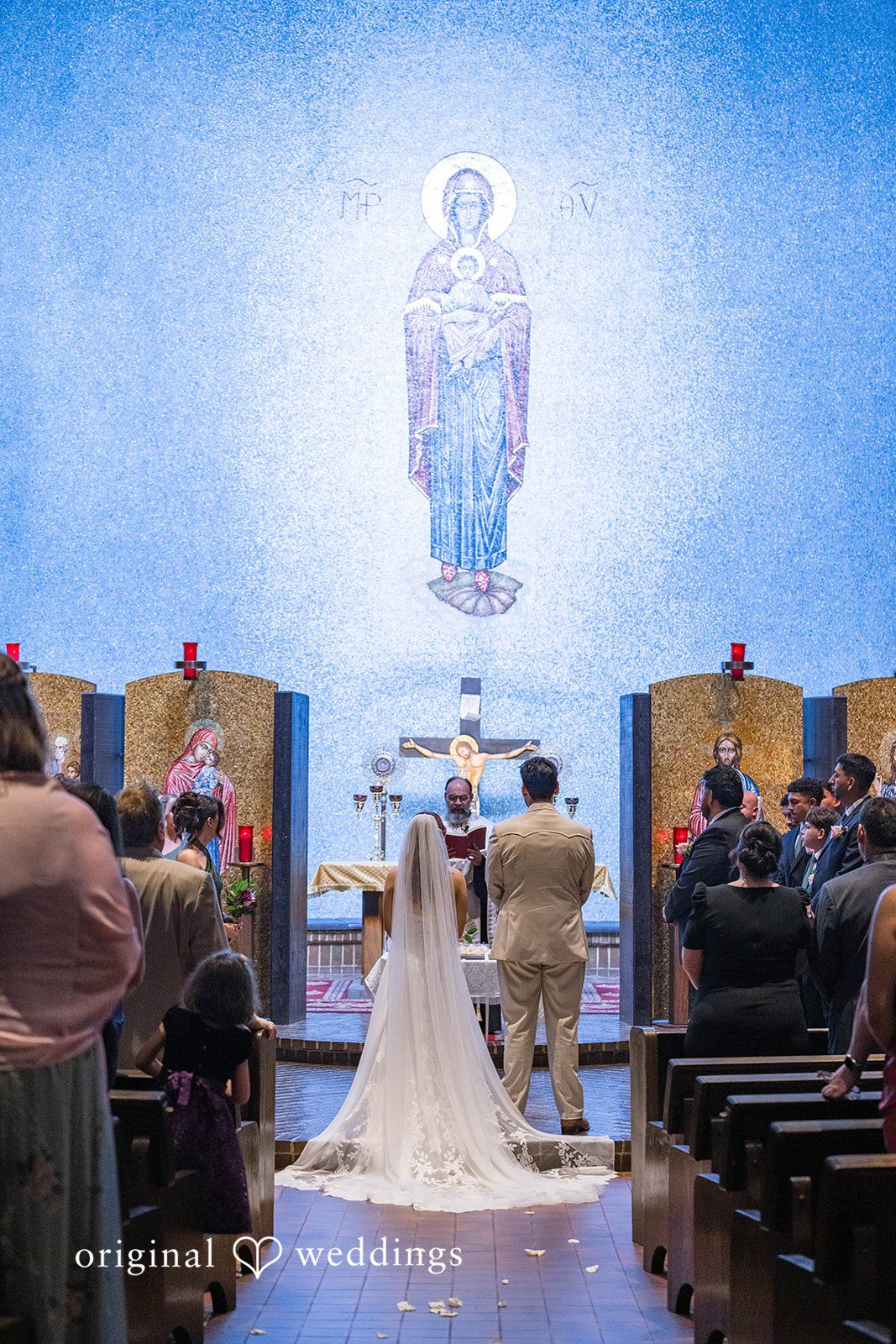 Andrea + Roberto Couple beneath the church icons during the ceremony