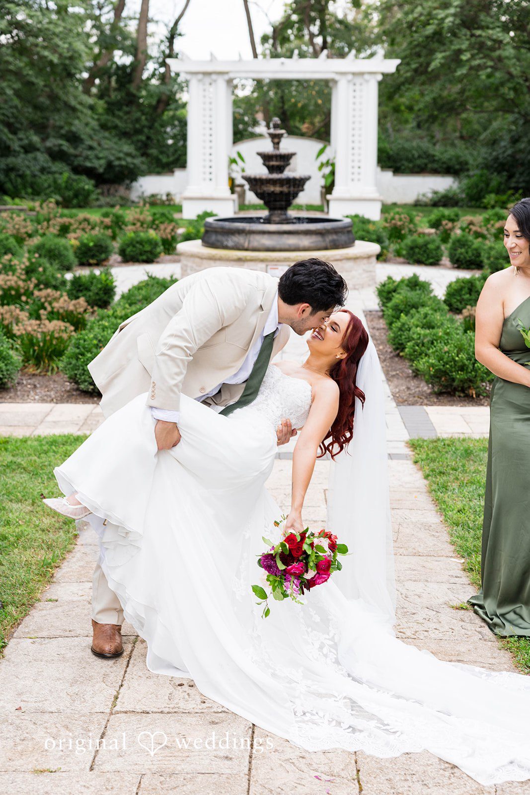 Andrea + Roberto Couple sharing a dip kiss by the garden gazebo