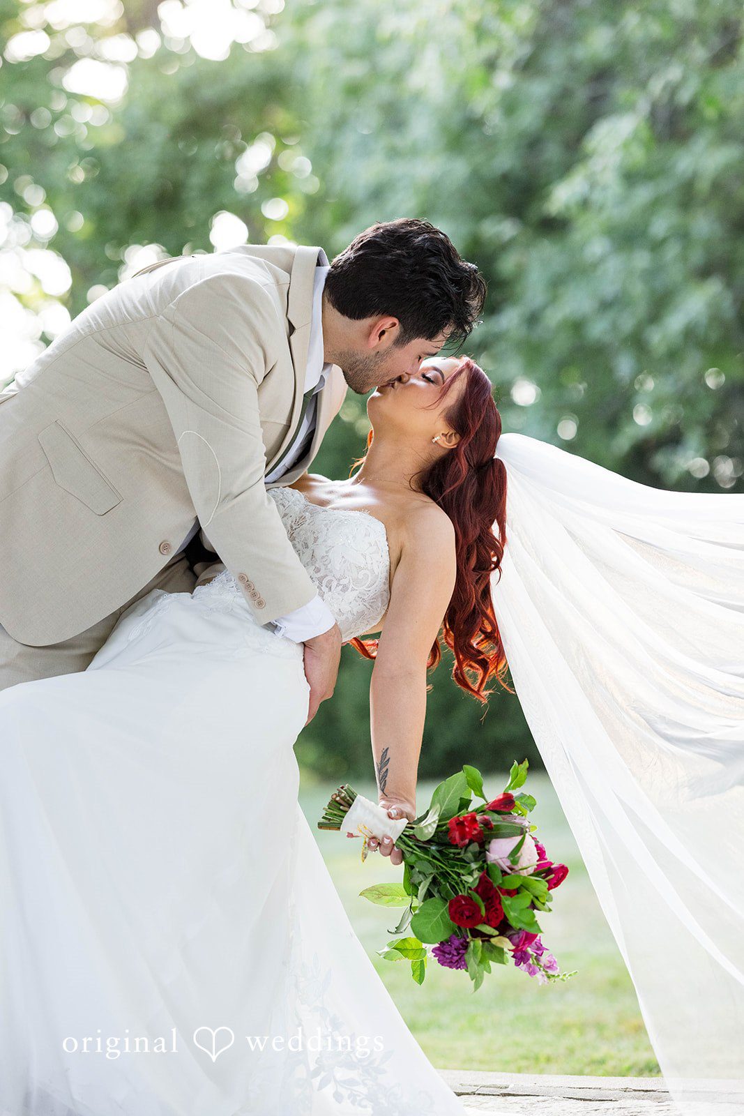 Andrea + Roberto Groom dipping the bride for a kiss on the lawn