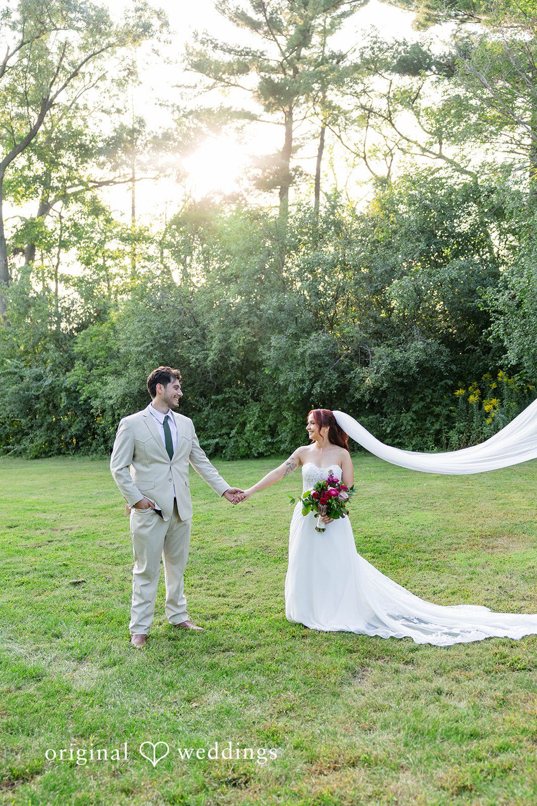 Andrea + Roberto Couple on the lawn with the veil flowing behind