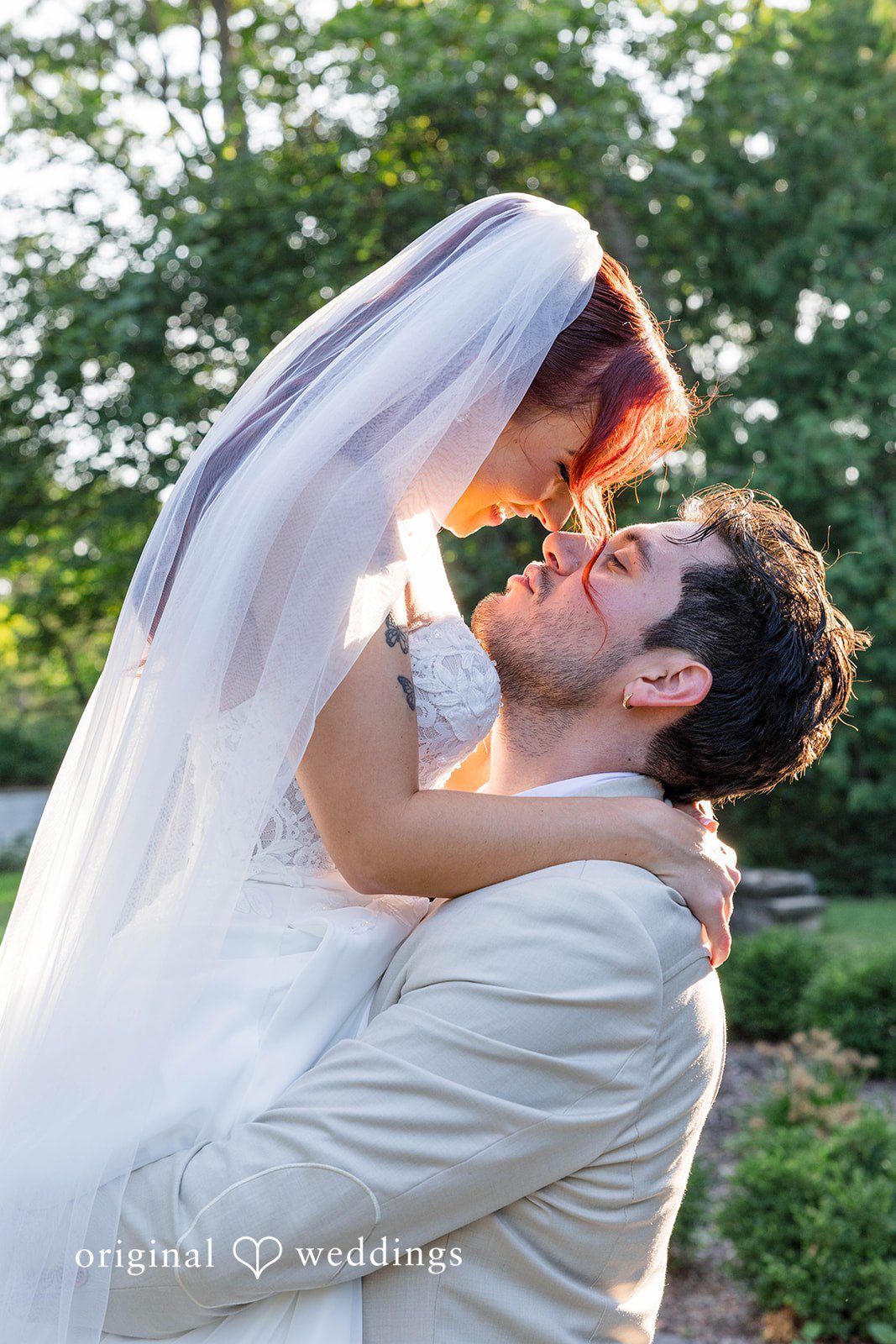 Andrea + Roberto Bride and groom kissing under the veil