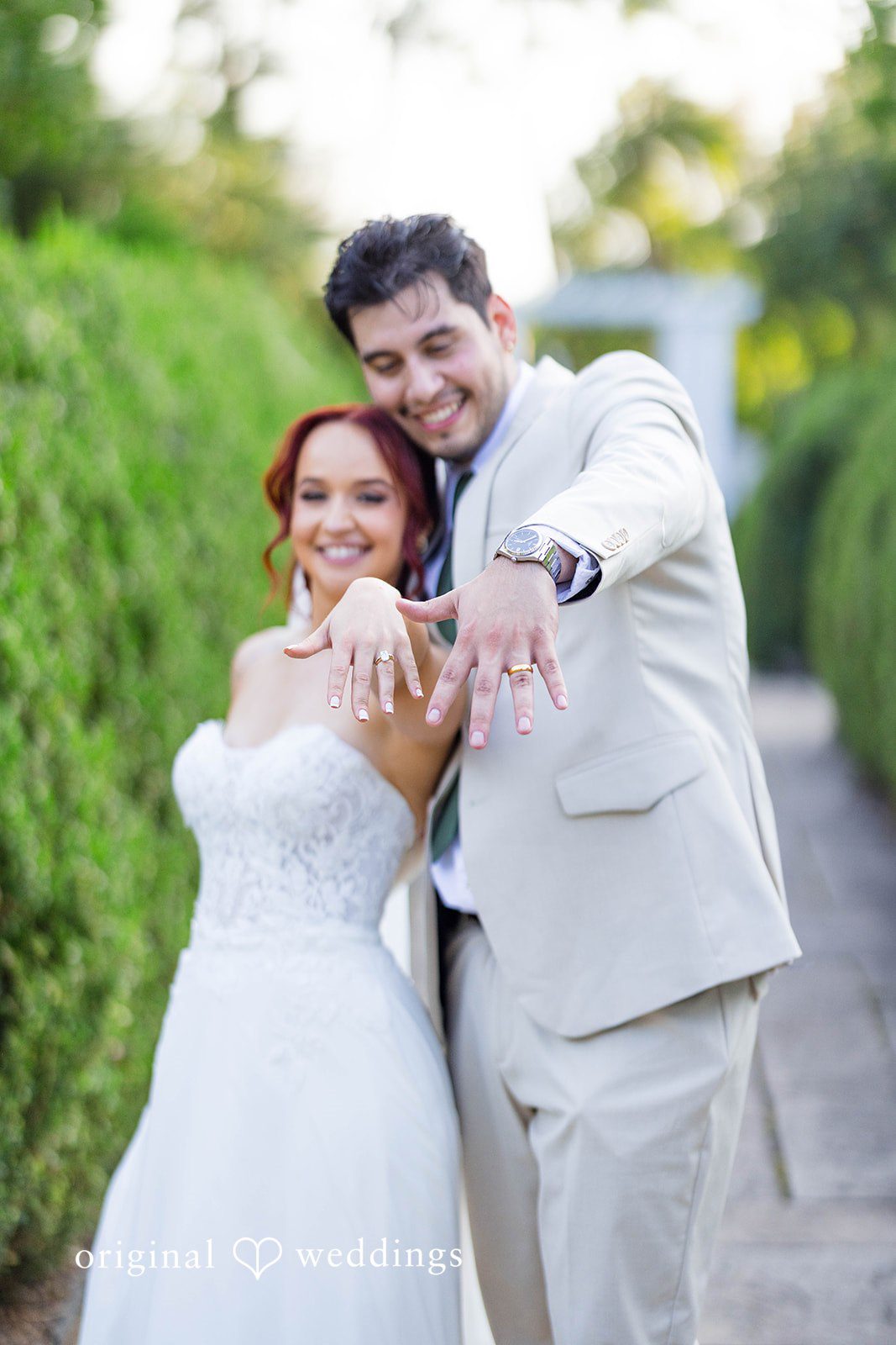 Andrea + Roberto Bride and groom showing off their wedding rings outdoors