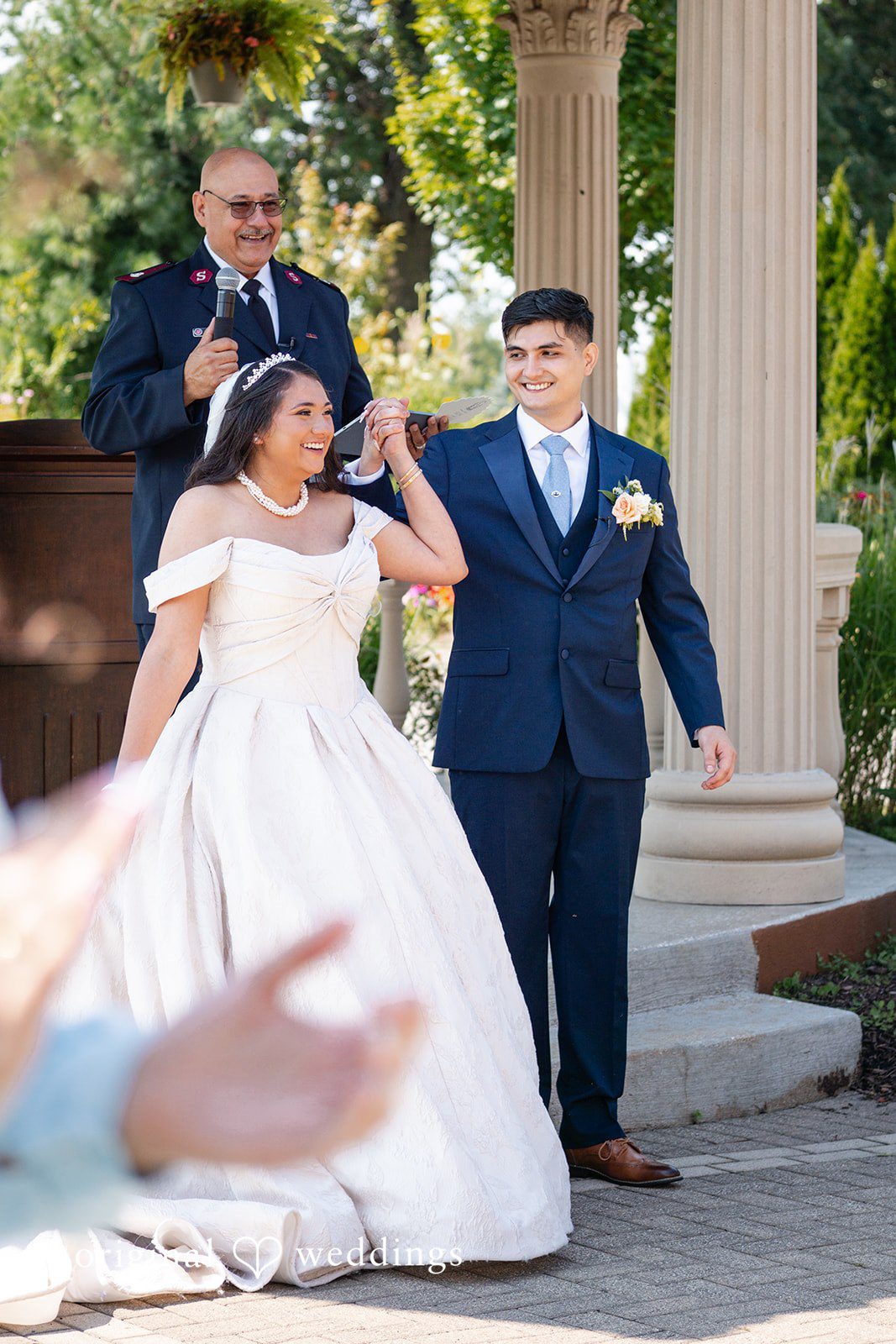 Selena + Ezequiel A bride and groom make their grand entrance down a set of outdoor stone steps.