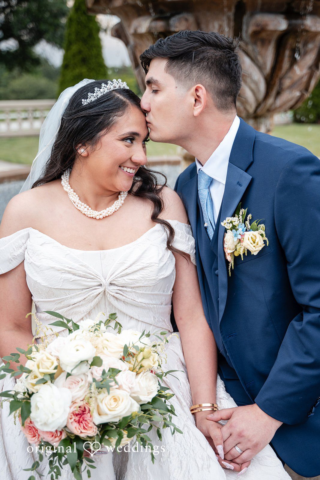 Selena + Ezequiel A bride and groom smile and look at each other while posing closely together.