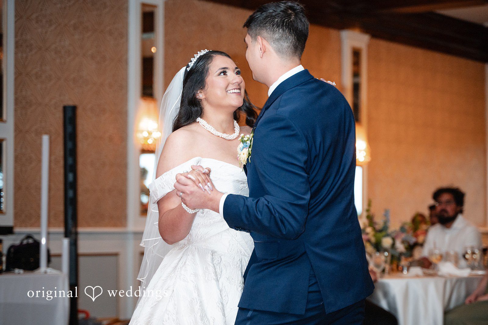 Selena + Ezequiel A bride and groom look affectionately at each other while slow dancing at their wedding reception.