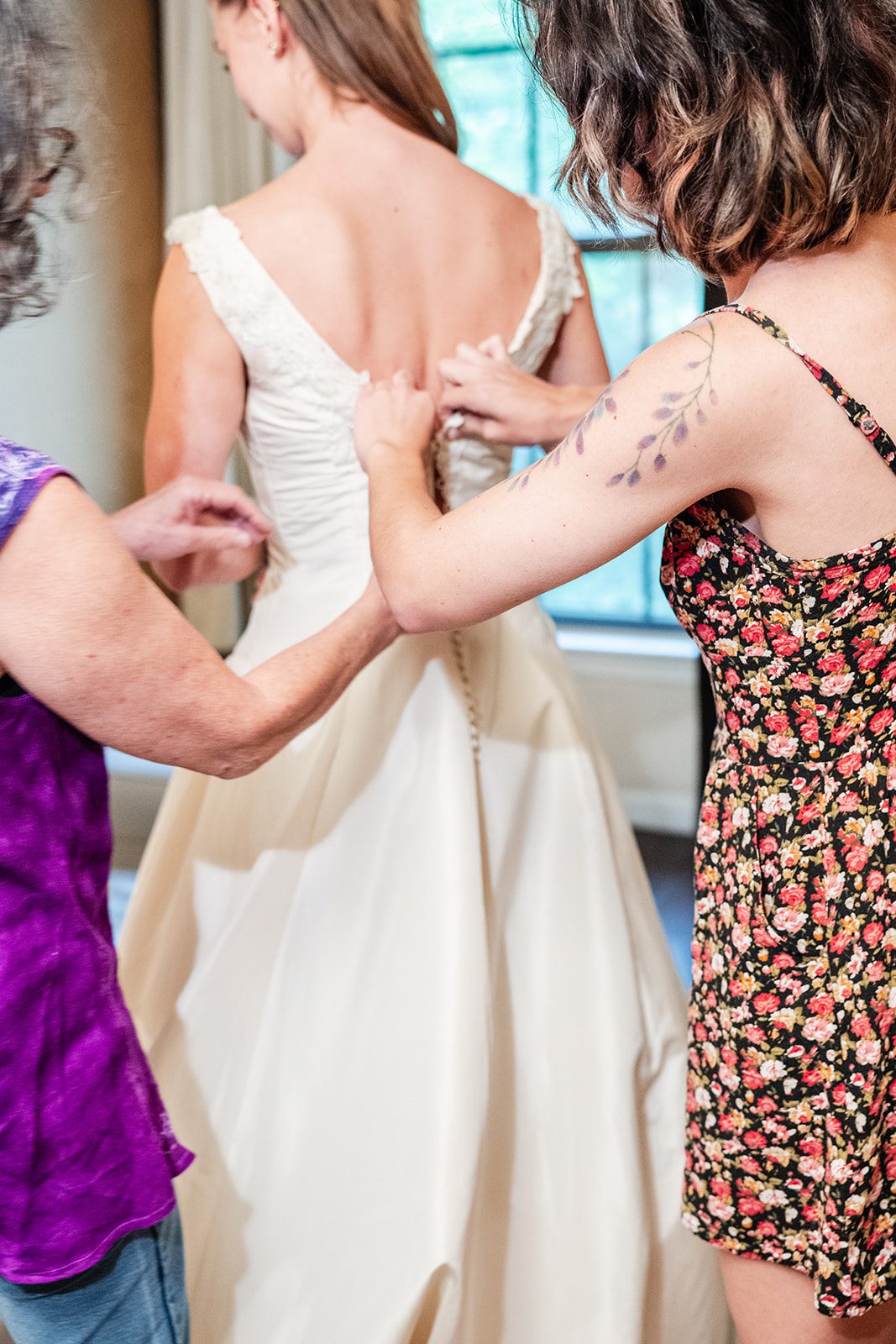 Bride getting help with her gown
