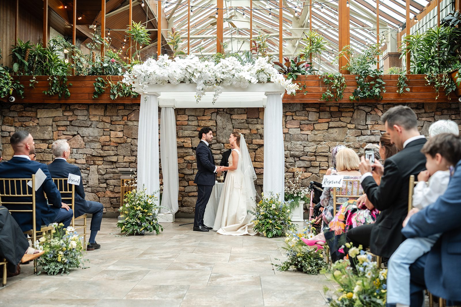 Wide view of the ceremony under the arch at The Fox Hollow