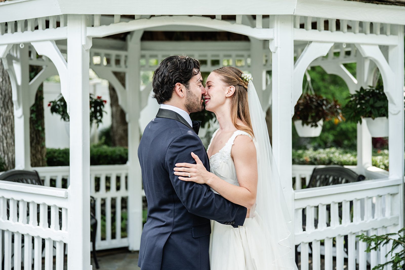 Bride and groom by the white gazebo at The Fox Hollow