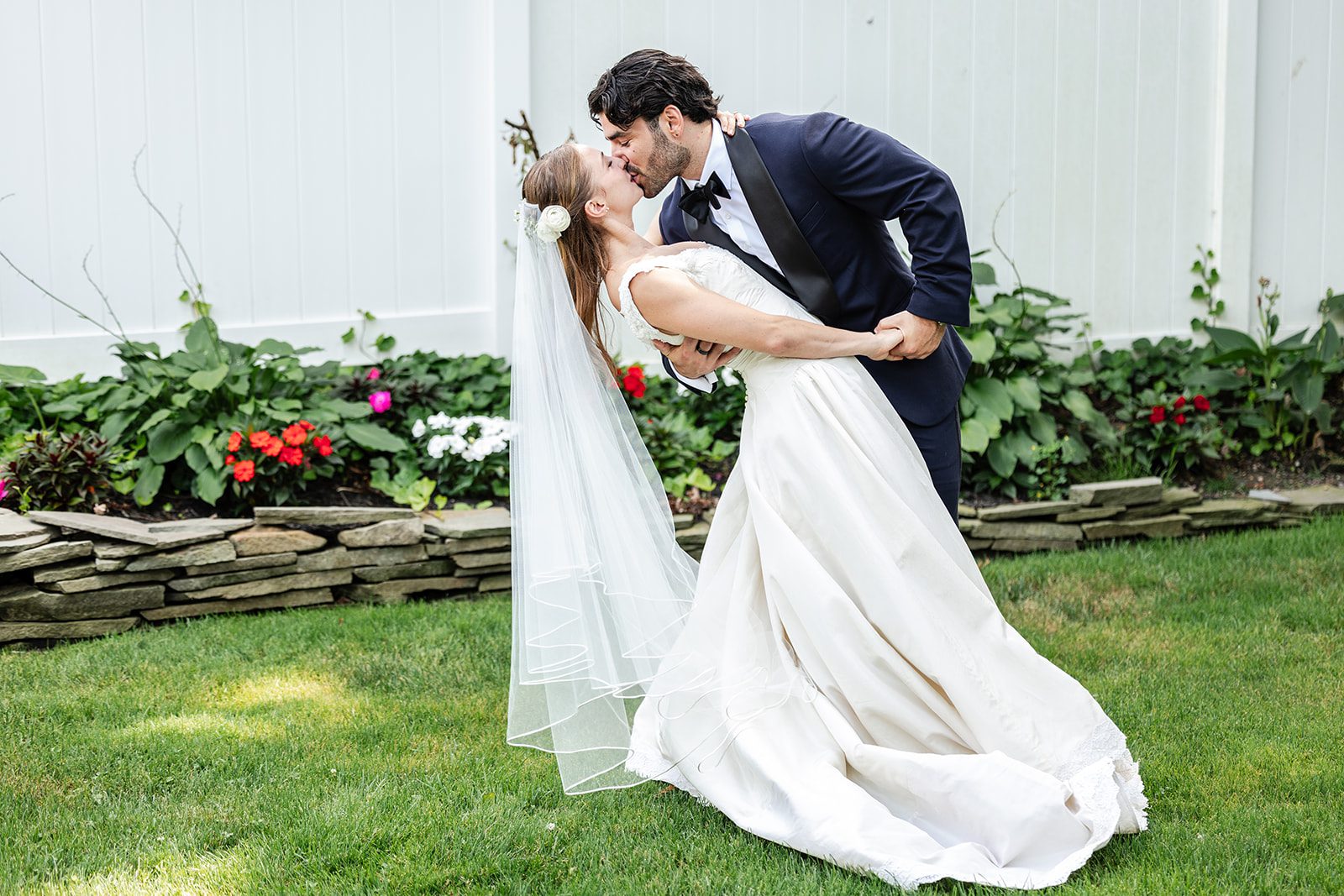 Couple sharing a kiss on the lawn at The Fox Hollow