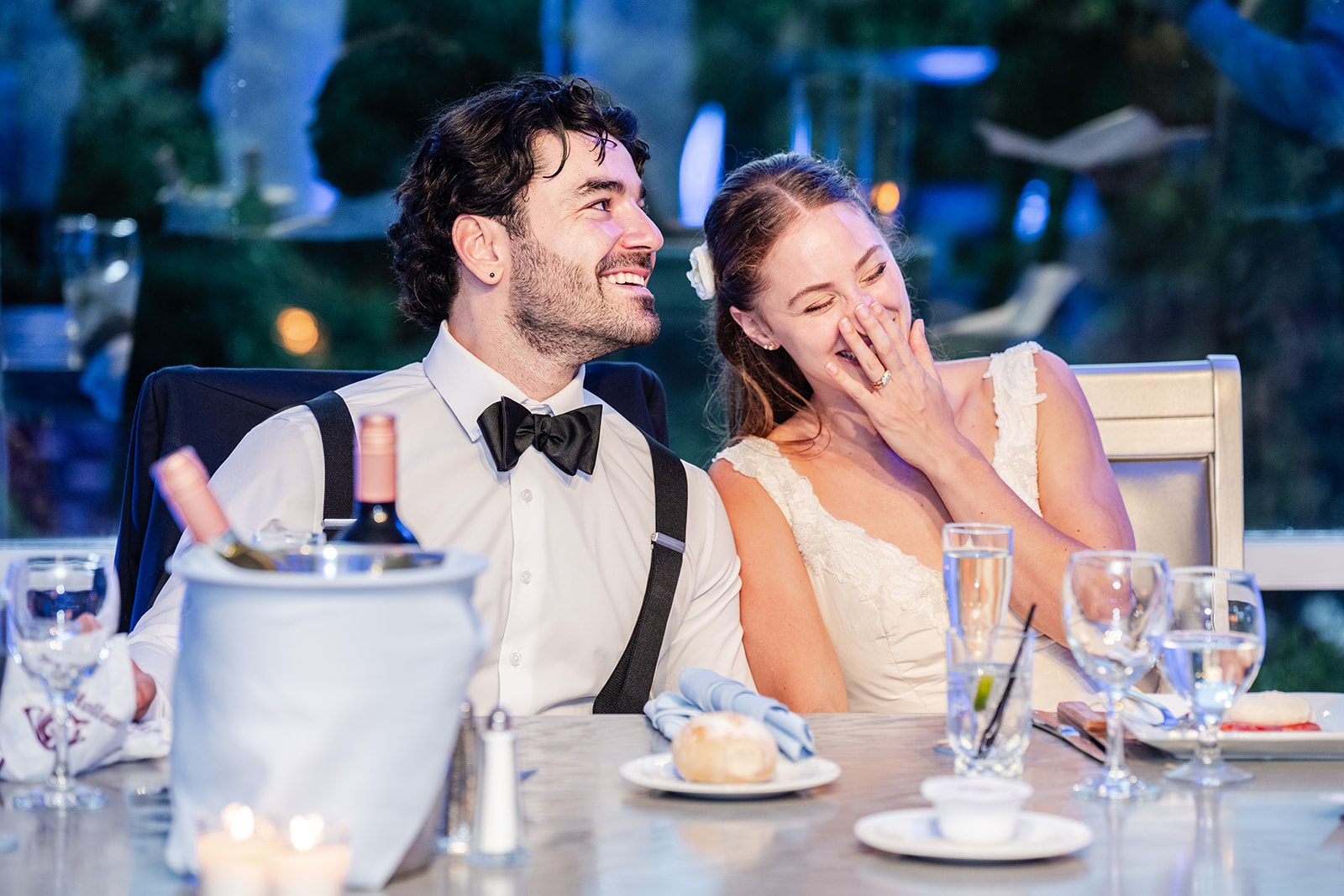 Couple laughing at their sweetheart table