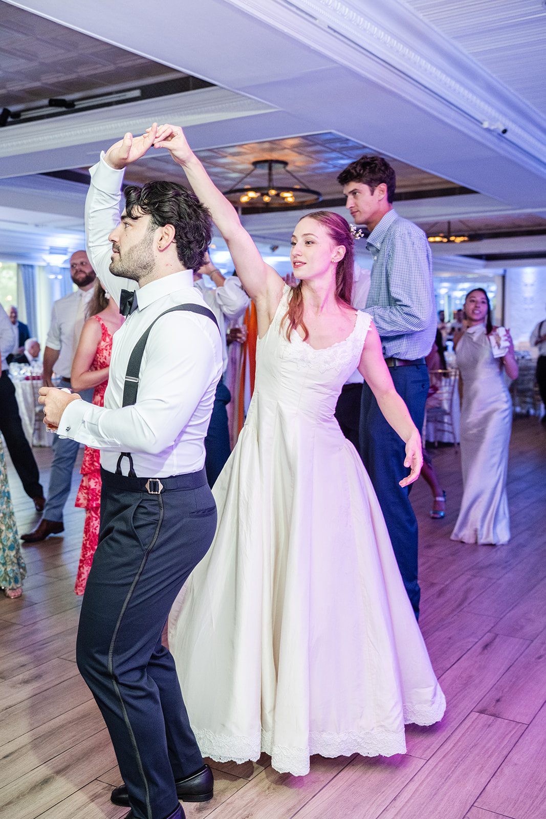 Newlyweds dancing with friends